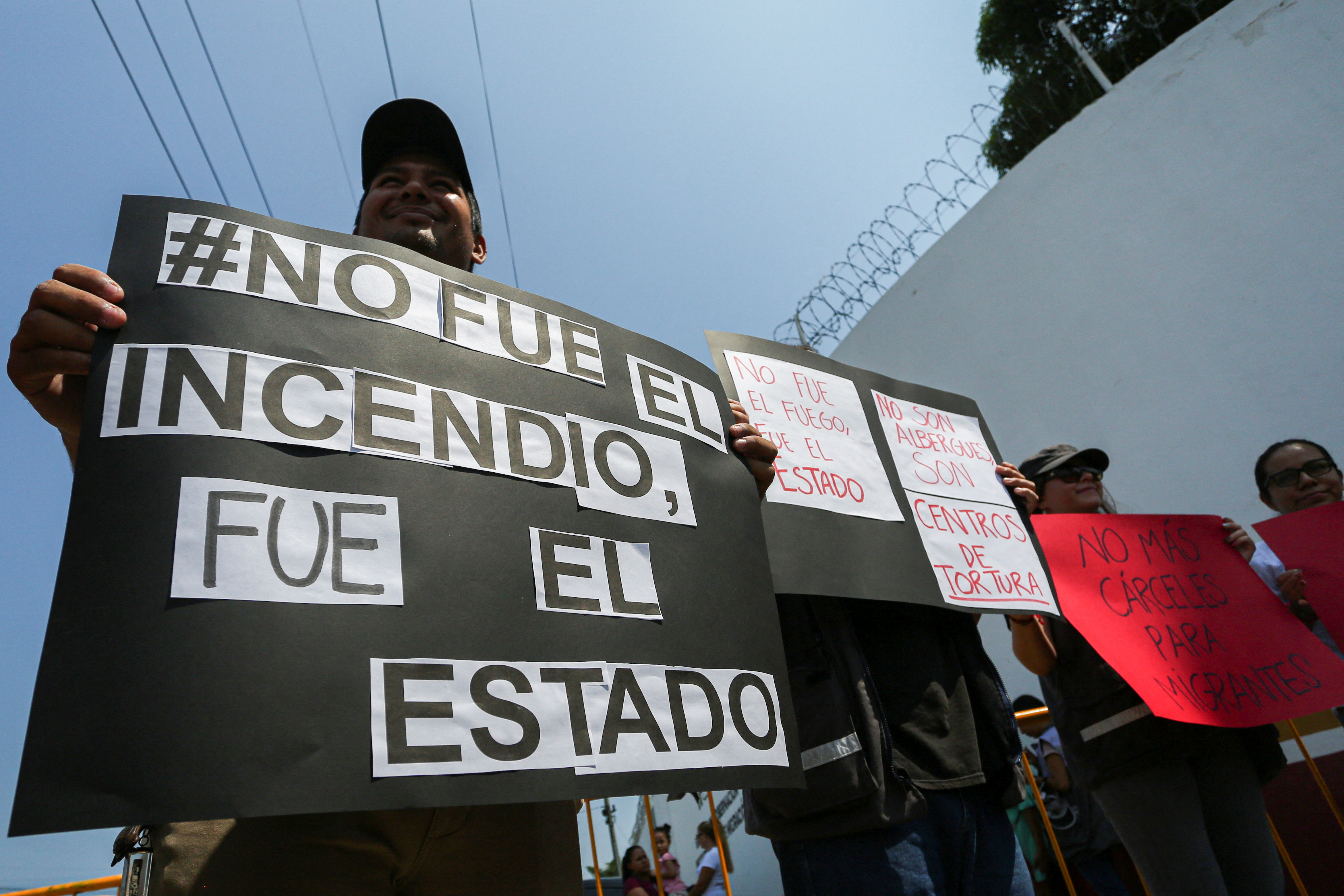 Activists hold placards as they block the entrance to the Siglo XXI migrant detention center, during a protest following the death of several migrants after a fire broke out at a migrant detention center late Monday in the border city of Ciudad Juarez, in Tapachula, Chiapas state, Mexico March 29, 2023. The placard reads: "It wasn't the fire. It was the State". REUTERS/Gabriela Sanabria NO RESALES. NO ARCHIVES