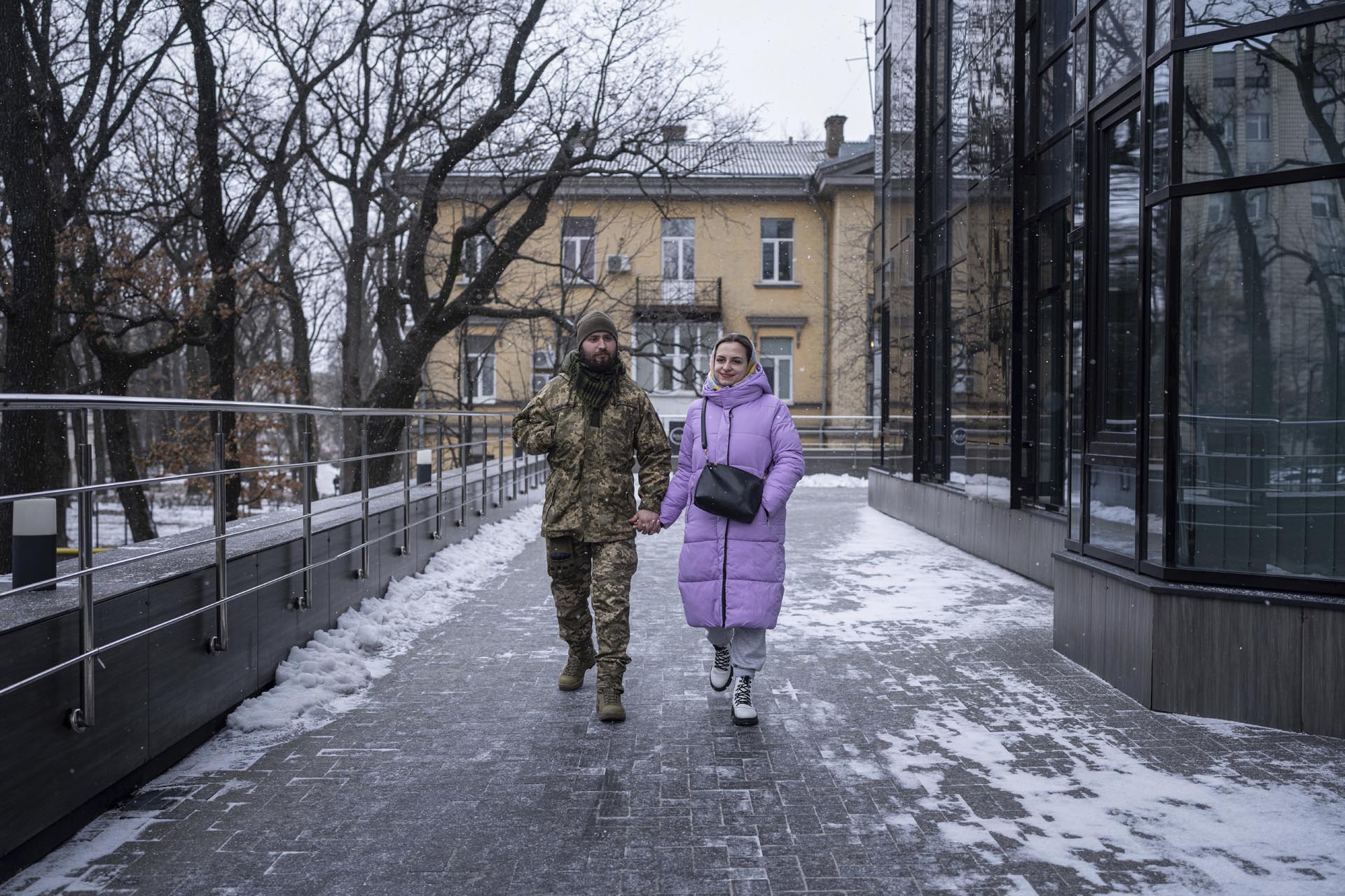El soldado ucraniano Vitalii Khroniuk y su compañera Anna Sokurenko caminan por una calle después de su visita a una clínica de fertilidad en Kiev, Ucrania. (Foto AP/Evgeniy Maloletka)
