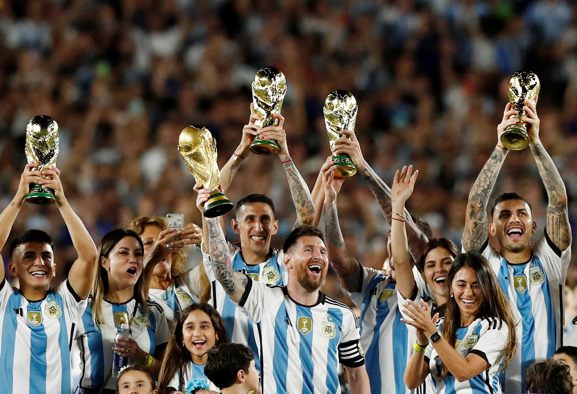 Soccer Football - International Friendly - Argentina v Panama - Estadio Monumental, Buenos Aires, Argentina - March 23, 2023 Argentina's Lionel Messi and teammates celebrate with their families and World Cup trophies after the match REUTERS/Agustin Marcarian     TPX IMAGES OF THE DAY