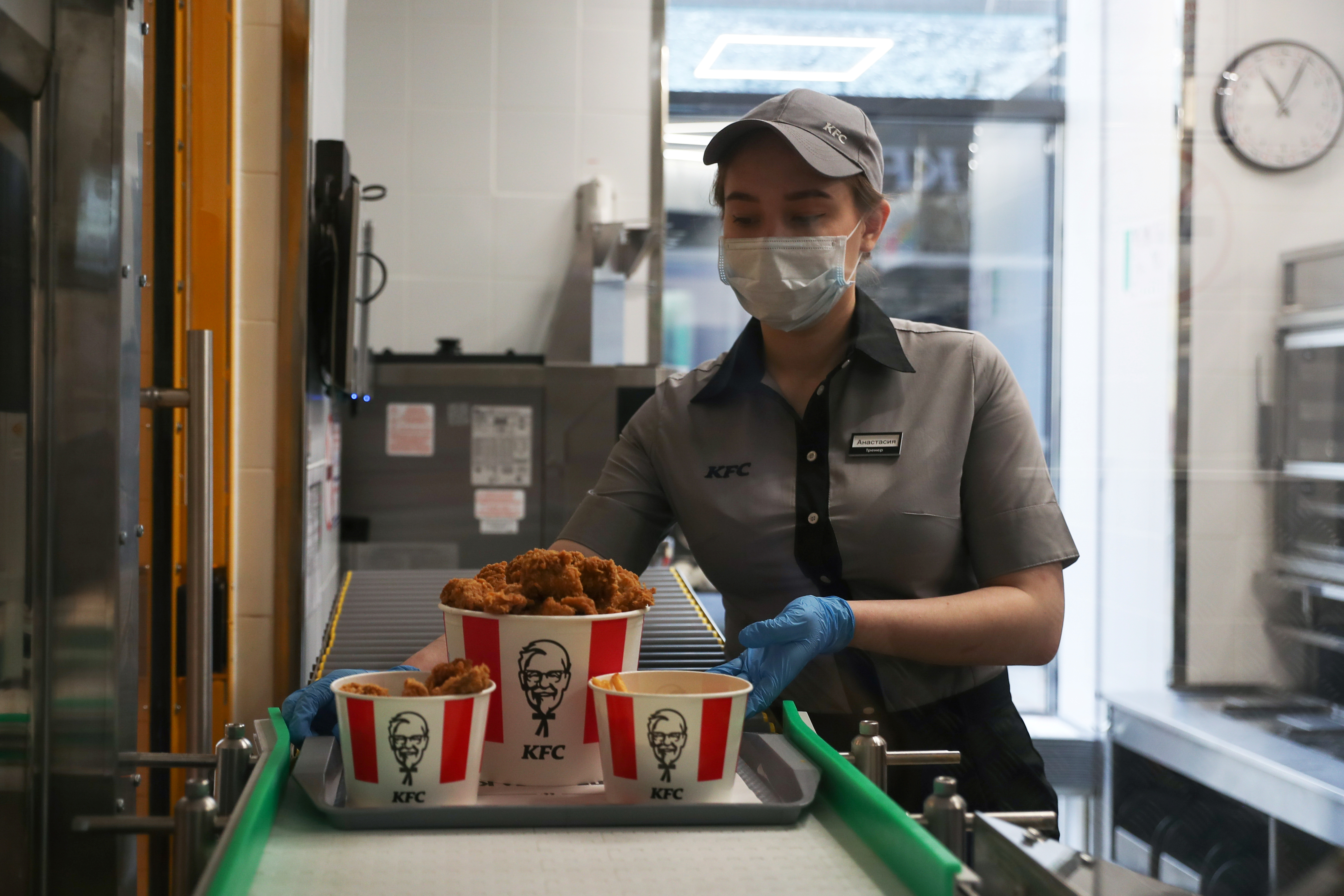 Un empleado coloca una bandeja de comida en una cinta transportadora en un restaurante de KFC que ofrece servicio sin contacto en Moscú, Rusia, el 21 de junio de 2020. REUTERS/Evgenia Novozhenina