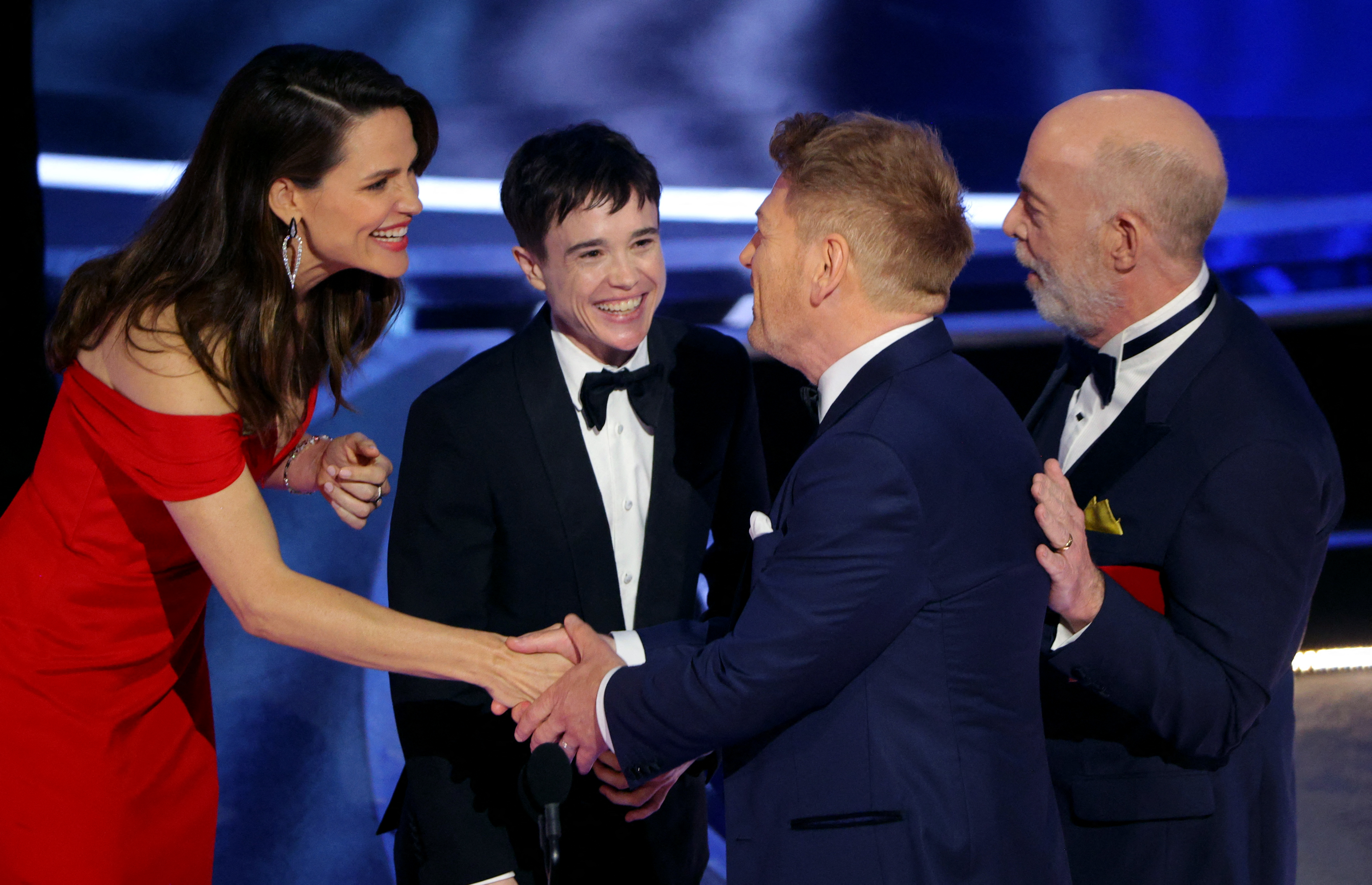 Kenneth Branagh accepts the Oscar for Best Original Screenplay for "Belfast" from presenters Jennifer Garner (L), Elliot Page, and J.K. Simmons at the 94th Academy Awards in Hollywood, Los Angeles, California, U.S., March 27, 2022. REUTERS/Brian Snyder REFILE - ADDING ADDITIONAL CAPTION INFO