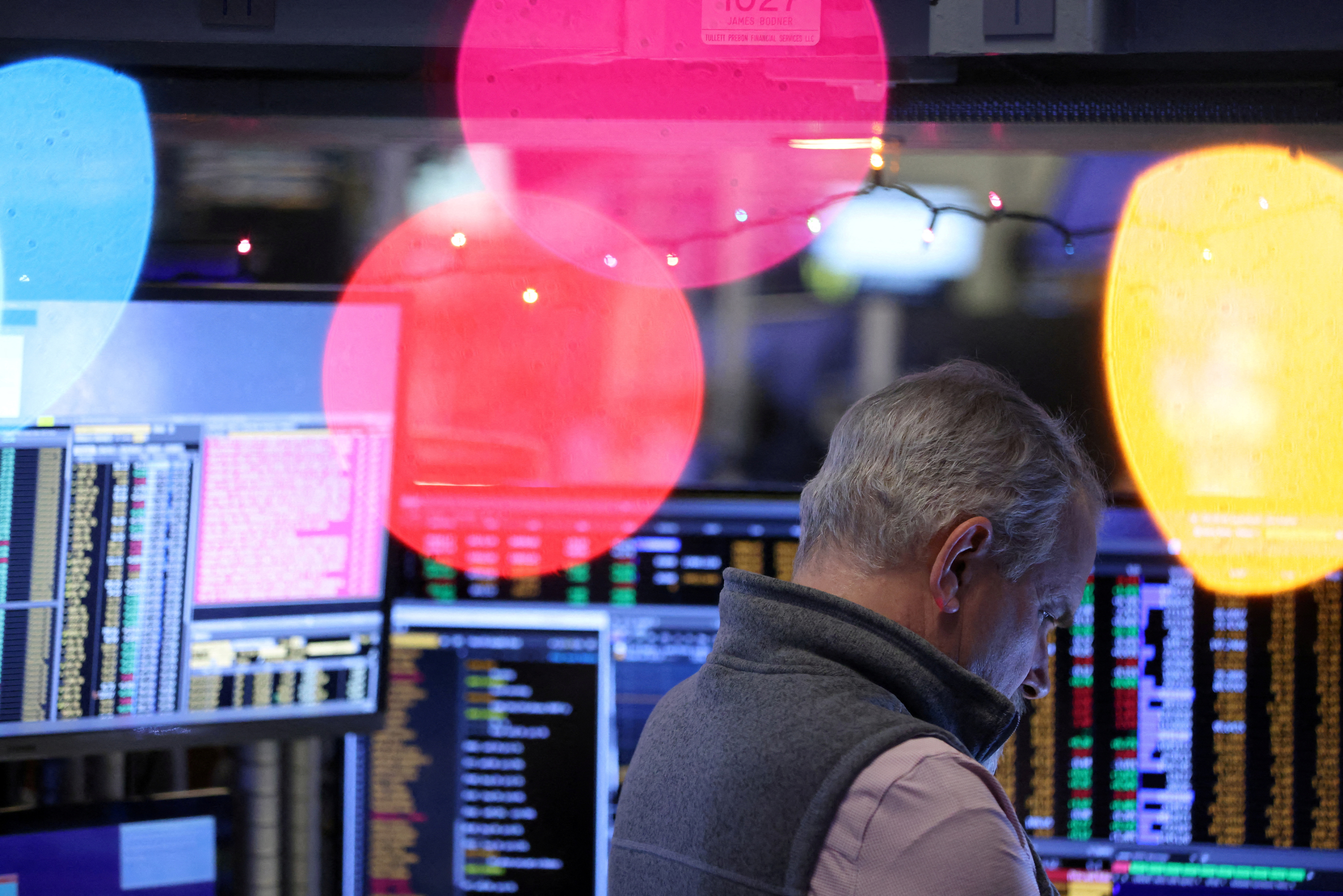 FILE PHOTO: A trader works on the trading floor of the New York Stock Exchange (NYSE) in New York City, US, December 14, 2022. REUTERS/Andrew Kelly/File Photo