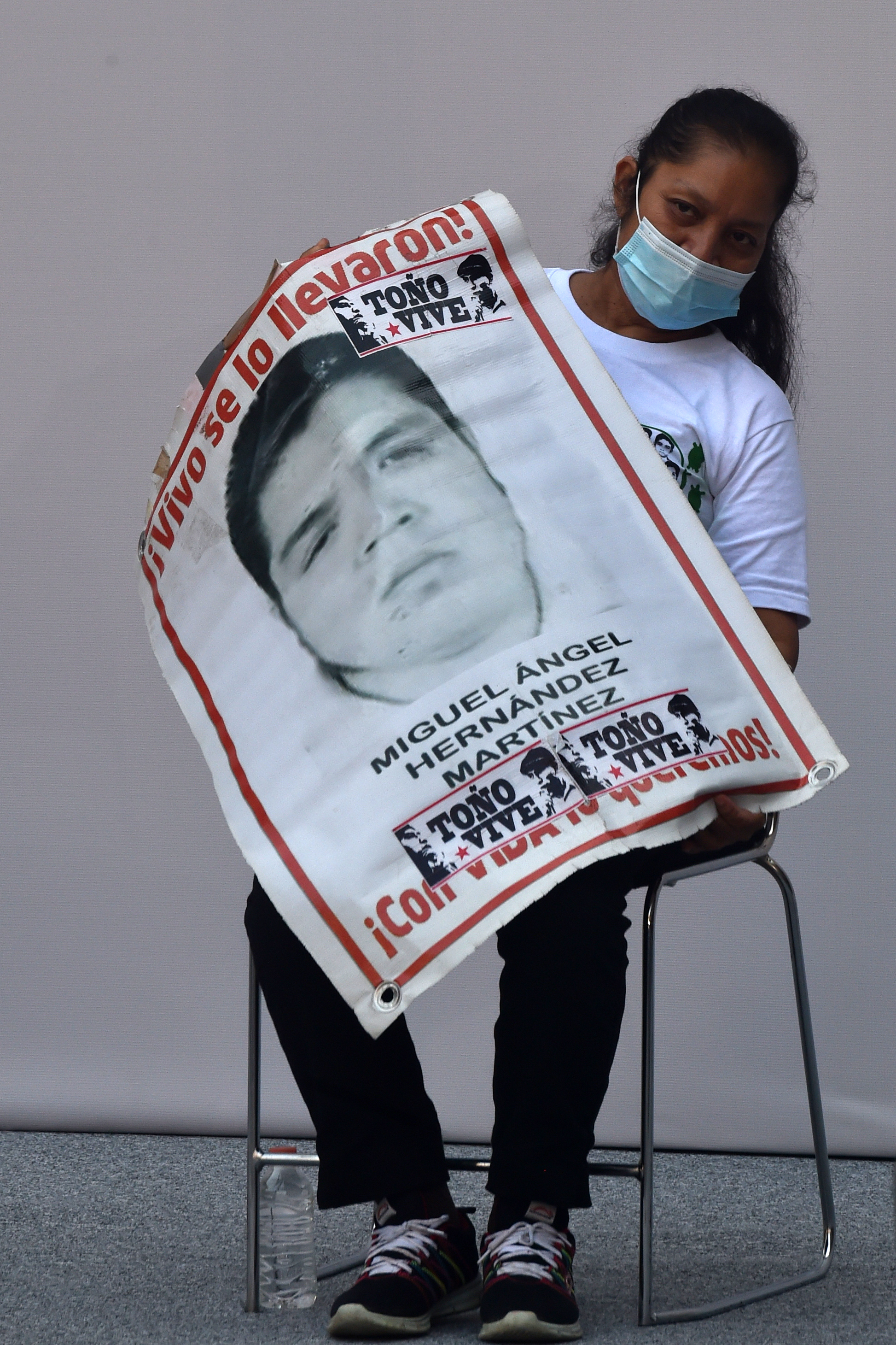 Mexico's President Andres Manuel Lopez Obrador, left, and Deputy Interior Secretary Alejandro Encinas, right, applaud for Maria Martinez, mother of Miguel Angel Hernandez Martinez, as she is introduced as a representative of the family members of 43 missing students from the Rural Normal School of Ayotzinapa, during an event to update the ongoing investigations on the sixth anniversary of the students’ disappearance, at the National Palace in Mexico City, Saturday, Sept. 26, 2020. (AP Photo/Rebecca Blackwell)