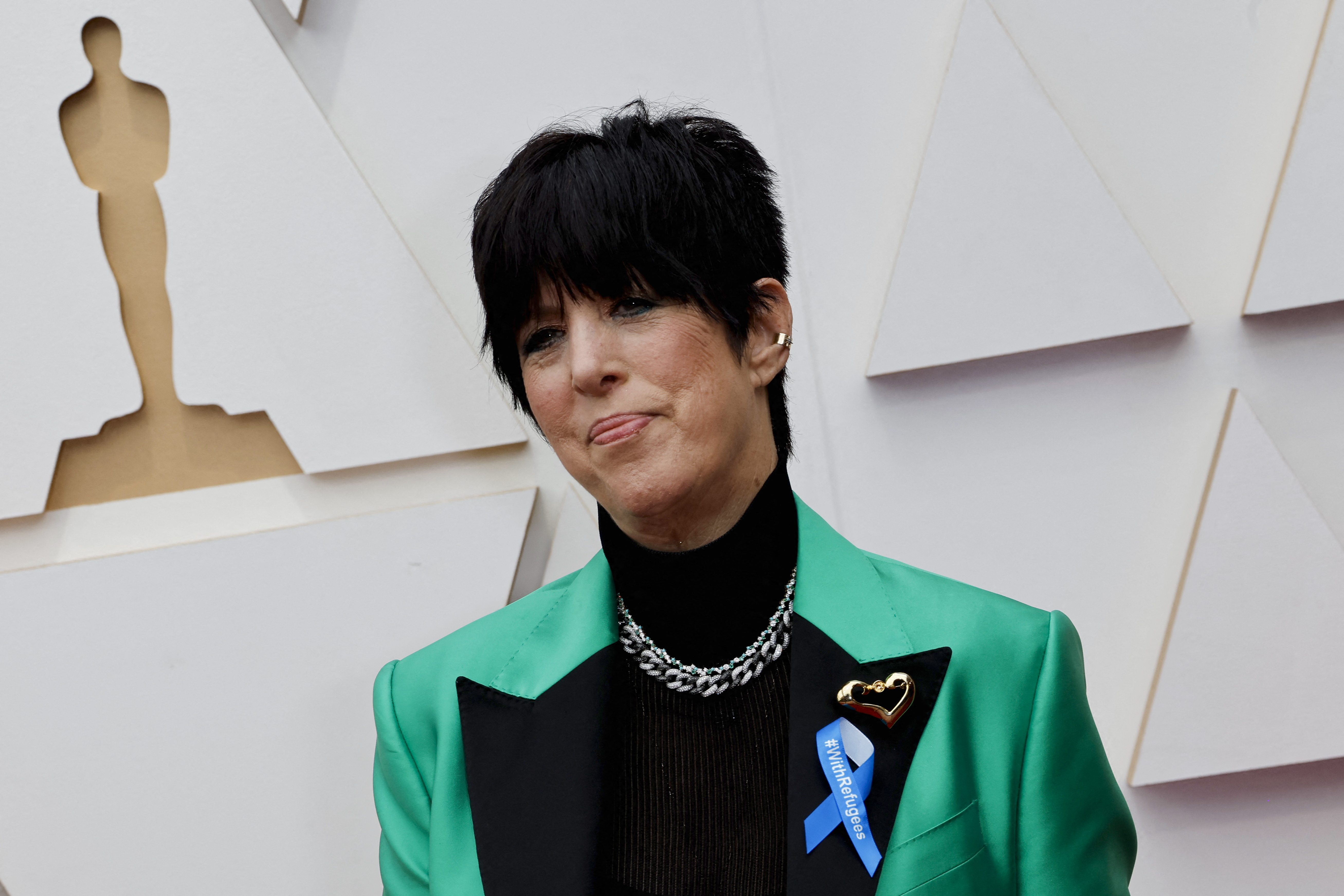 Diane Warren wears a ribbon reading "With Refugees" supporting global refugees as she poses on the red carpet during the Oscars arrivals at the 94th Academy Awards in Hollywood, Los Angeles, California, U.S., March 27, 2022. REUTERS/Eric Gaillard