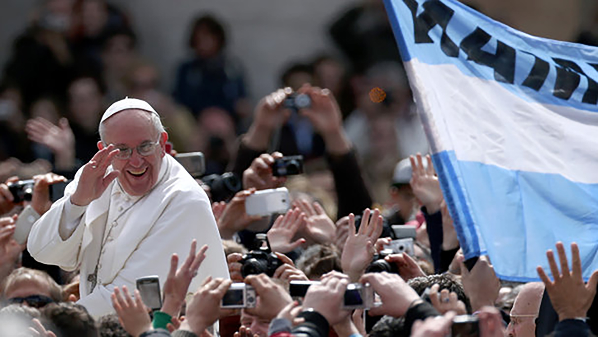 El Papa en un acto público flanqueado por una bandera argentinas
