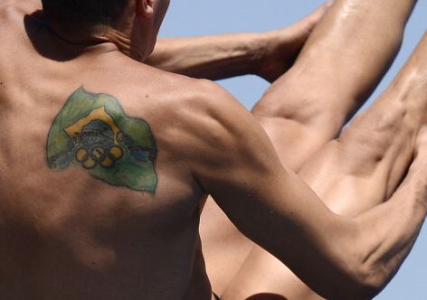 A picture shows the Brazilian flag with the Olympic Rings tatooed on the shoulder of Brazil's Cesar Castro as he competes in the men's 3-metre springboard semi-final diving event in the FINA World Championships at the Piscina Municipal de Montjuic in Barcelona on July 25, 2013. The 2016 Olympic Games will be held in Rio, Brazil.  AFP PHOTO / JAVIER SORIANO        (Photo credit should read JAVIER SORIANO/AFP/Getty Images)