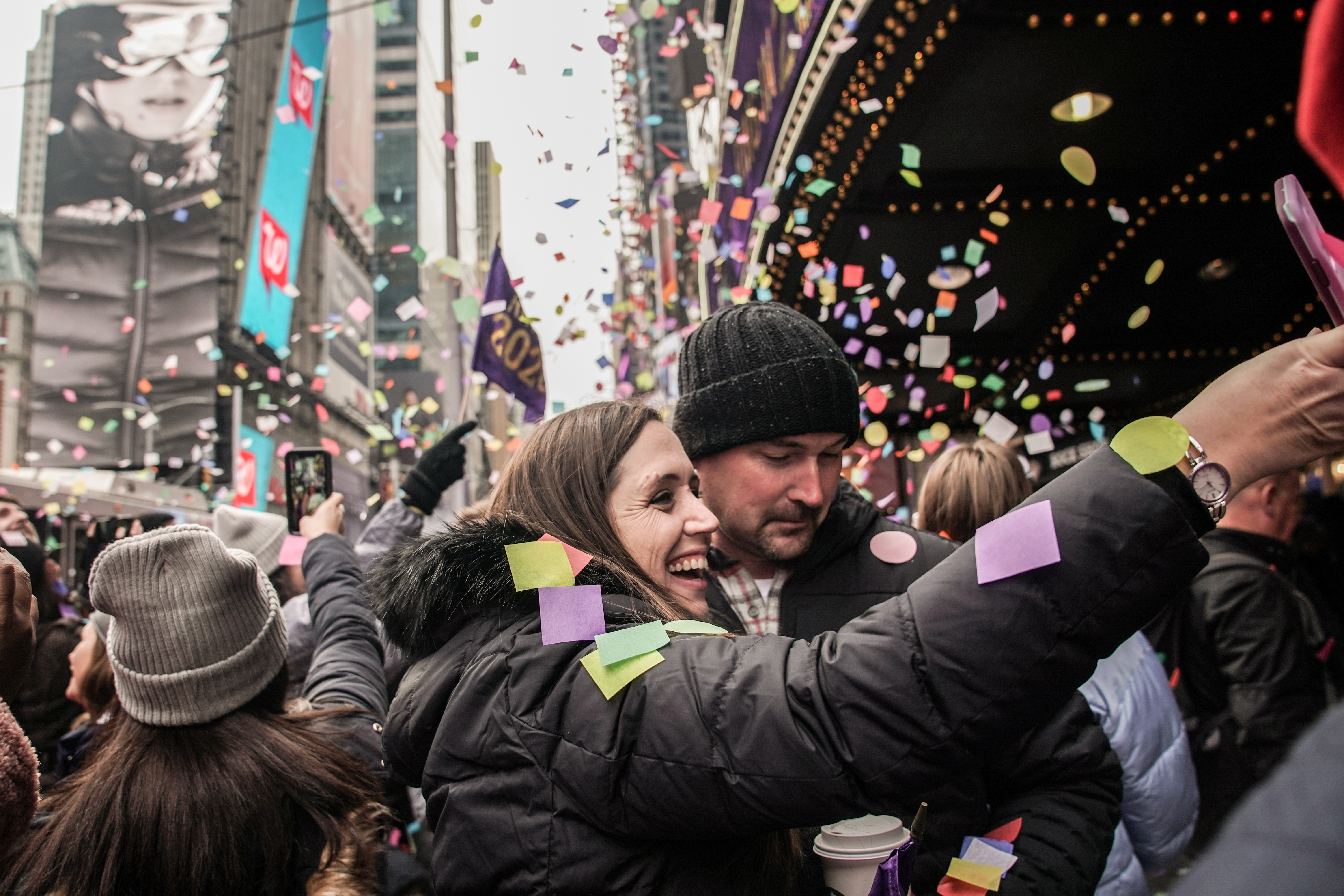 People take a picture at confetti as it's thrown from the Hard Rock Cafe marquee as part of the annual confetti test ahead of the New Year's Eve ball-drop celebrations in Times Square in New York City, New York, U.S., December 29, 2019. REUTERS/Jeenah Moon