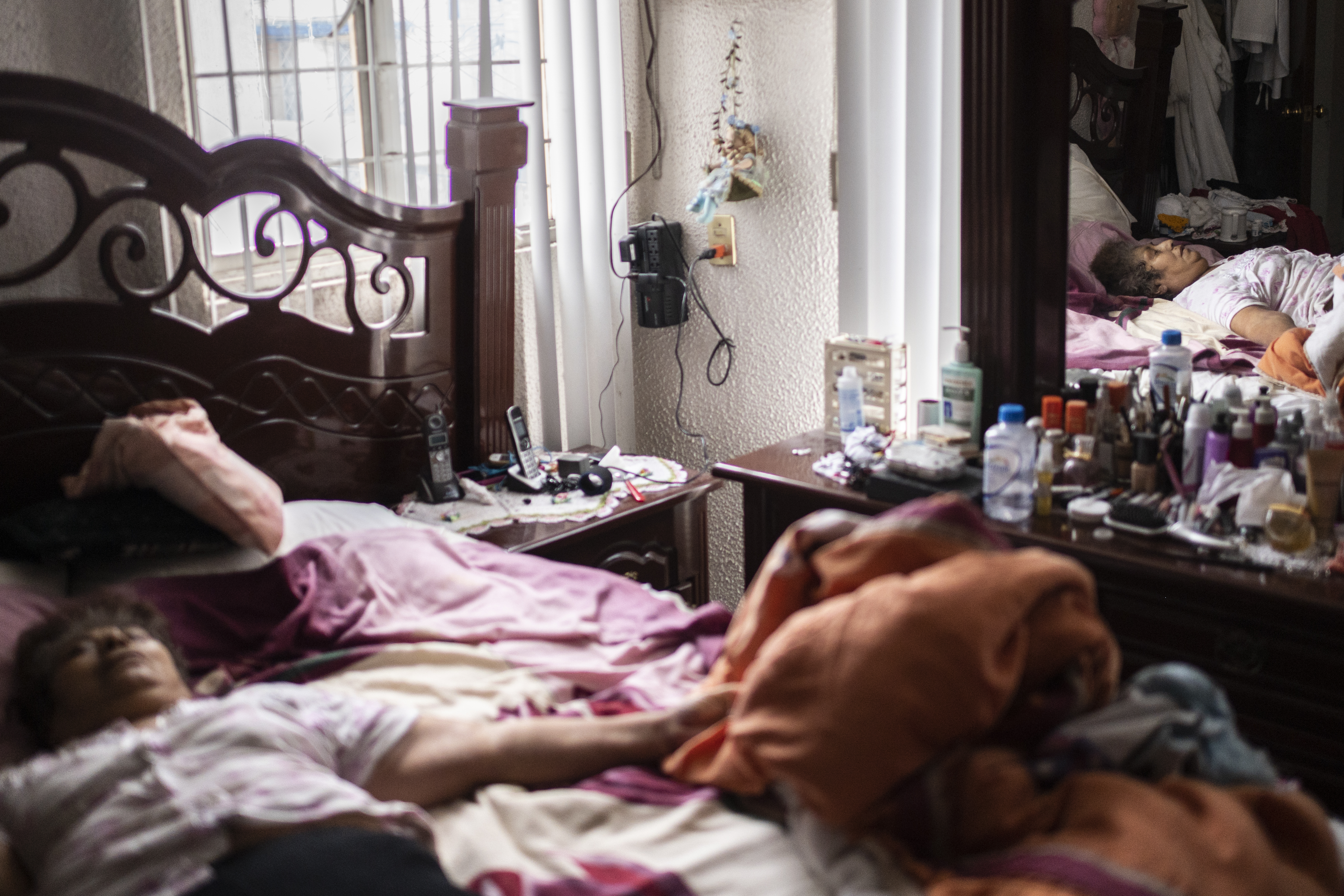Una mujer que murió por complicaciones de enfermedades crónicas y mostró síntomas de COVID-19, yace en su cama en Ciudad Nezahualcóyotl, Estado de México, México, el 21 de junio de 2020 durante la nueva pandemia de coronavirus de COVID-19. (Foto por Pedro PARDO / AFP)
