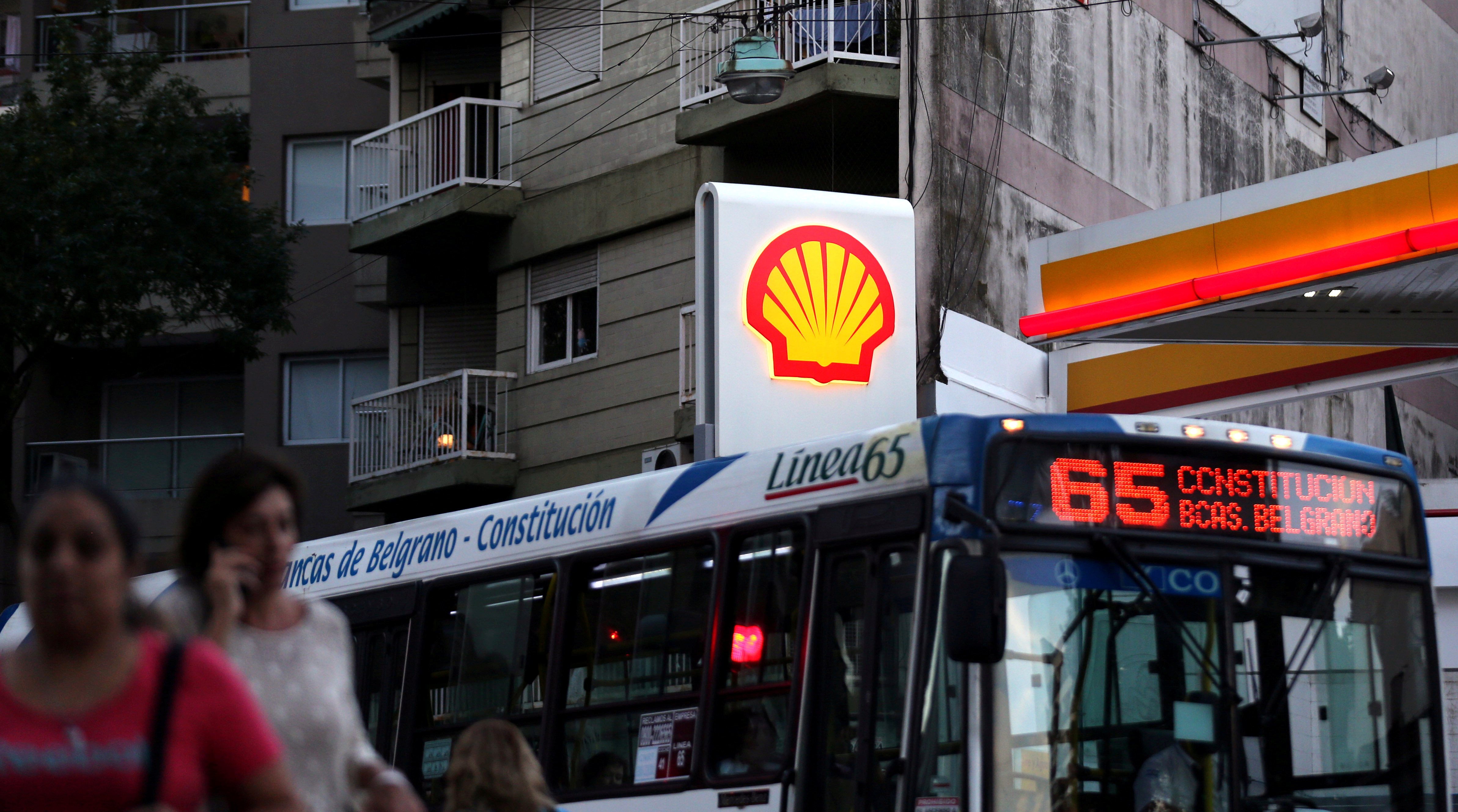 FILE PHOTO: People walk as a bus passes a Shell gas station in Buenos Aires, Argentina, March 12, 2018.  REUTERS/Marcos Brindicci/File Photo  GLOBAL BUSINESS WEEK AHEAD