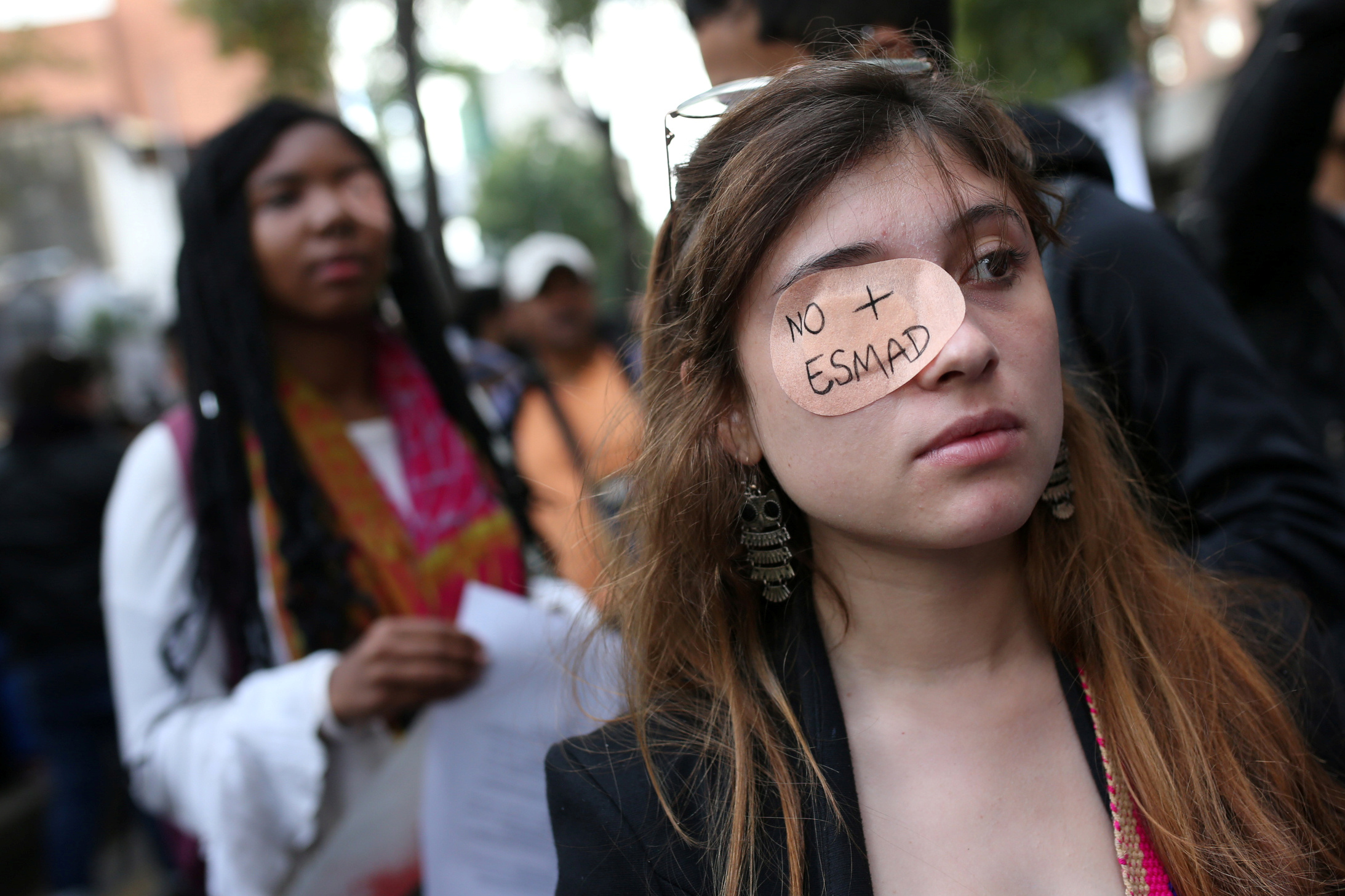 A woman with a patch on her eye that reads "No more ESMAD" is seen during a demonstration in honour of Dilan Cruz, a teenage demonstrator who died after being injured by a tear gas canister during an initial strike, in Bogota, Colombia December 23, 2019. REUTERS/Luisa Gonzalez