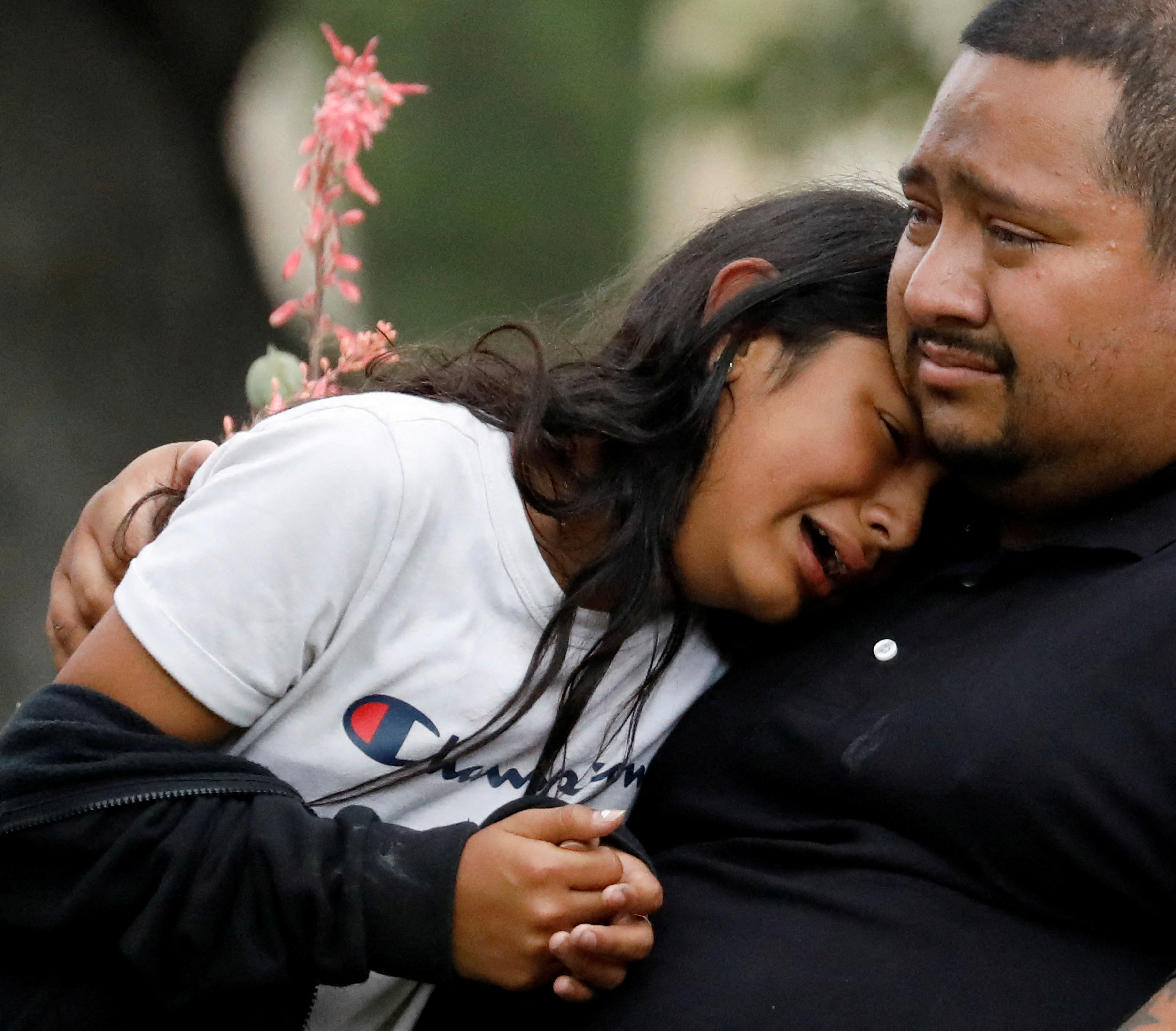 A man and a girl cry outside the Ssgt Willie de Leon Civic Center (REUTERS / Marco Bello)