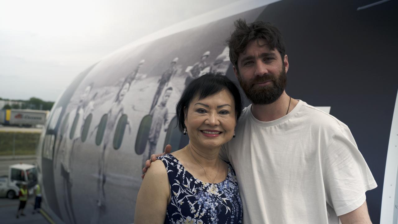 Kim Phuc con el enviado de Infobae y autor de esta nota, Joaquín Sánchez Mariño, junto al avión de Piñeyro ploteado con la foto que le tomaron a los 9 años quemada con napalm en Vietnam