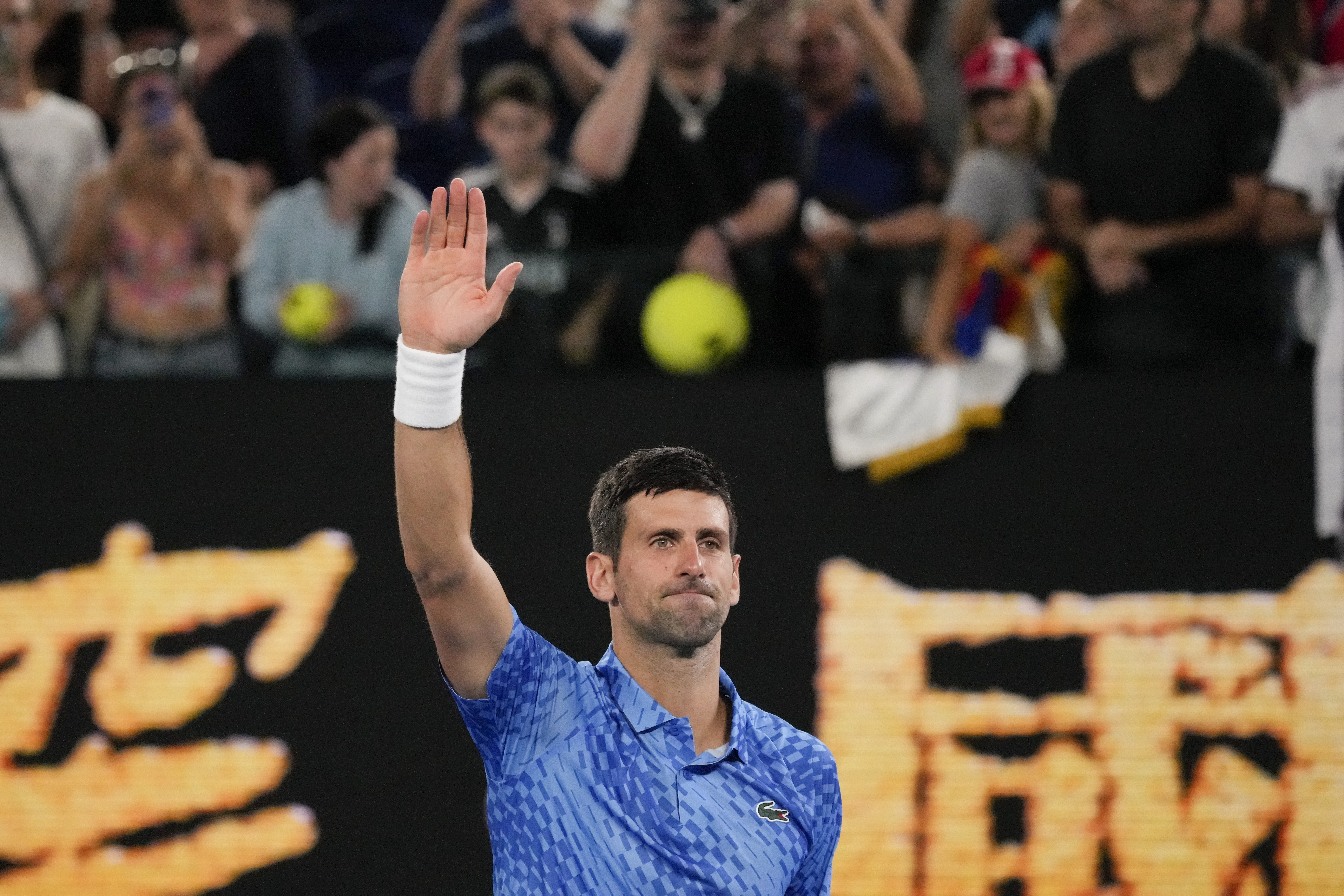 Novak Djokovic waves after beating Roberto Carballés Baena in the first round of the Australian Open, Wednesday, January 18, 2023, in Melbourne.  (AP Photo/Aaron Favila)