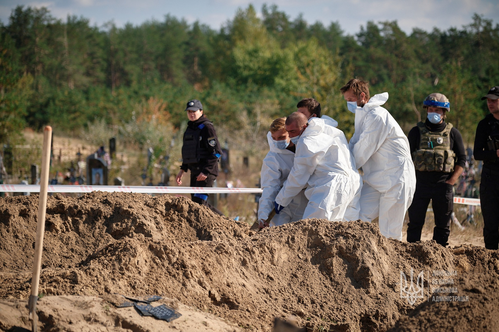 Forensic technicians and officers work in what appears to be a mass grave declared by regional governor Pavlo Kyrylenko located in the city of Lyman