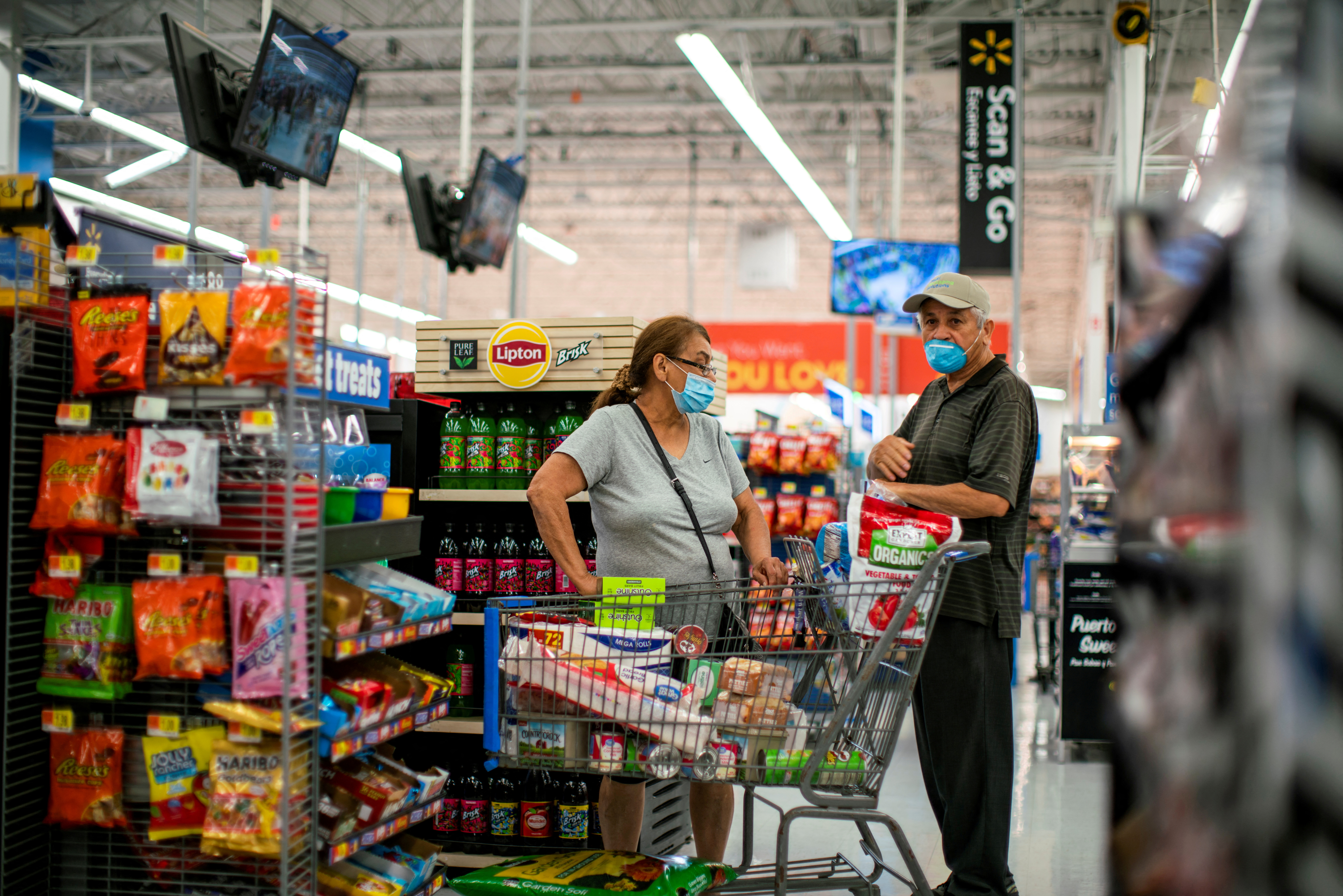 FILE PHOTO: Shoppers wear masks as they shop at a Walmart store, in North Brunswick, New Jersey, U.S., July 20, 2020. REUTERS/Eduardo Munoz/File Photo