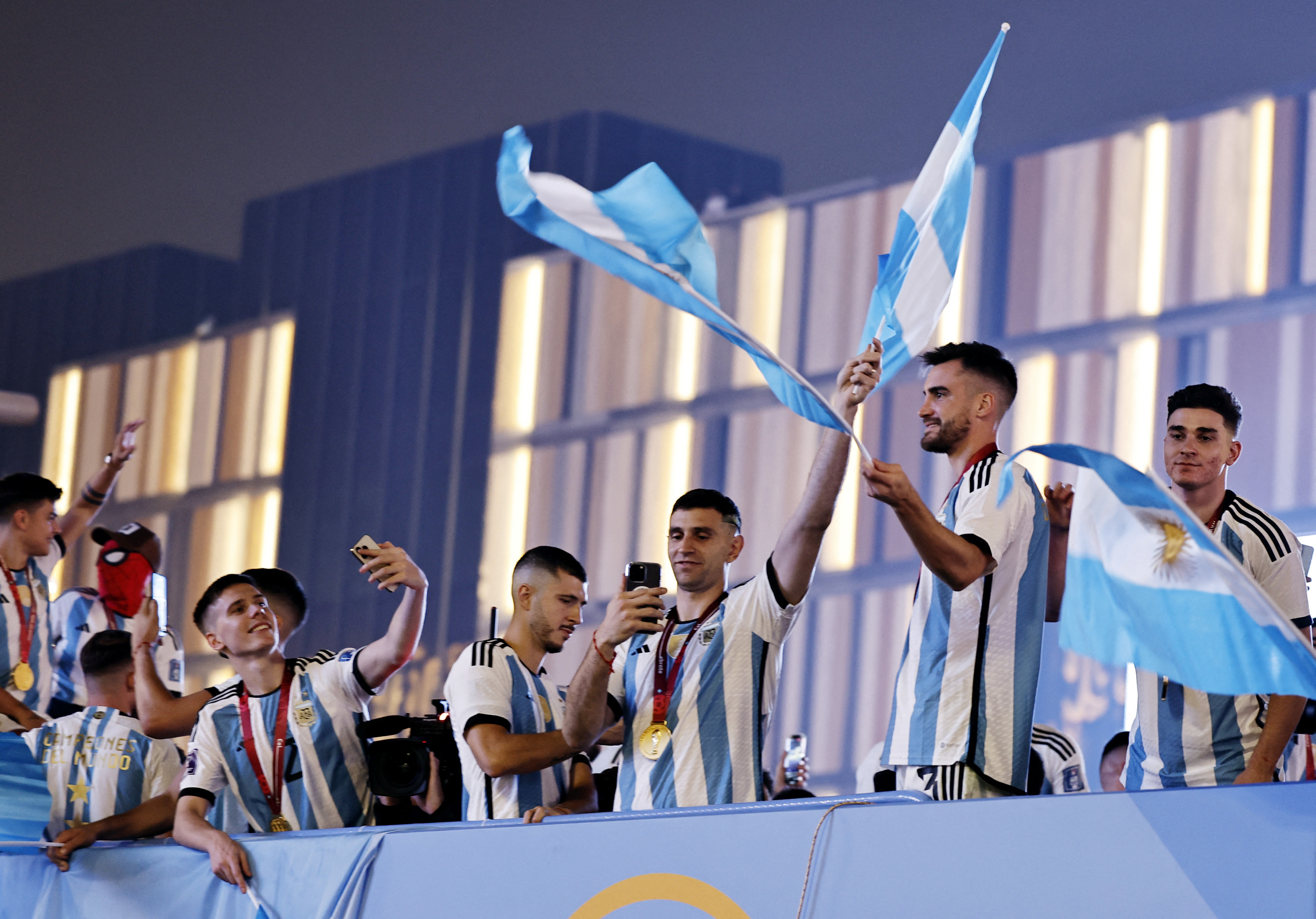 Soccer Football - FIFA World Cup Qatar 2022 - Final - Argentina v France - Lusail Stadium, Lusail, Qatar - December 19, 2022 Argentina players celebrate on a bus outside the stadium after winning the World Cup REUTERS/Hamad I Mohammed