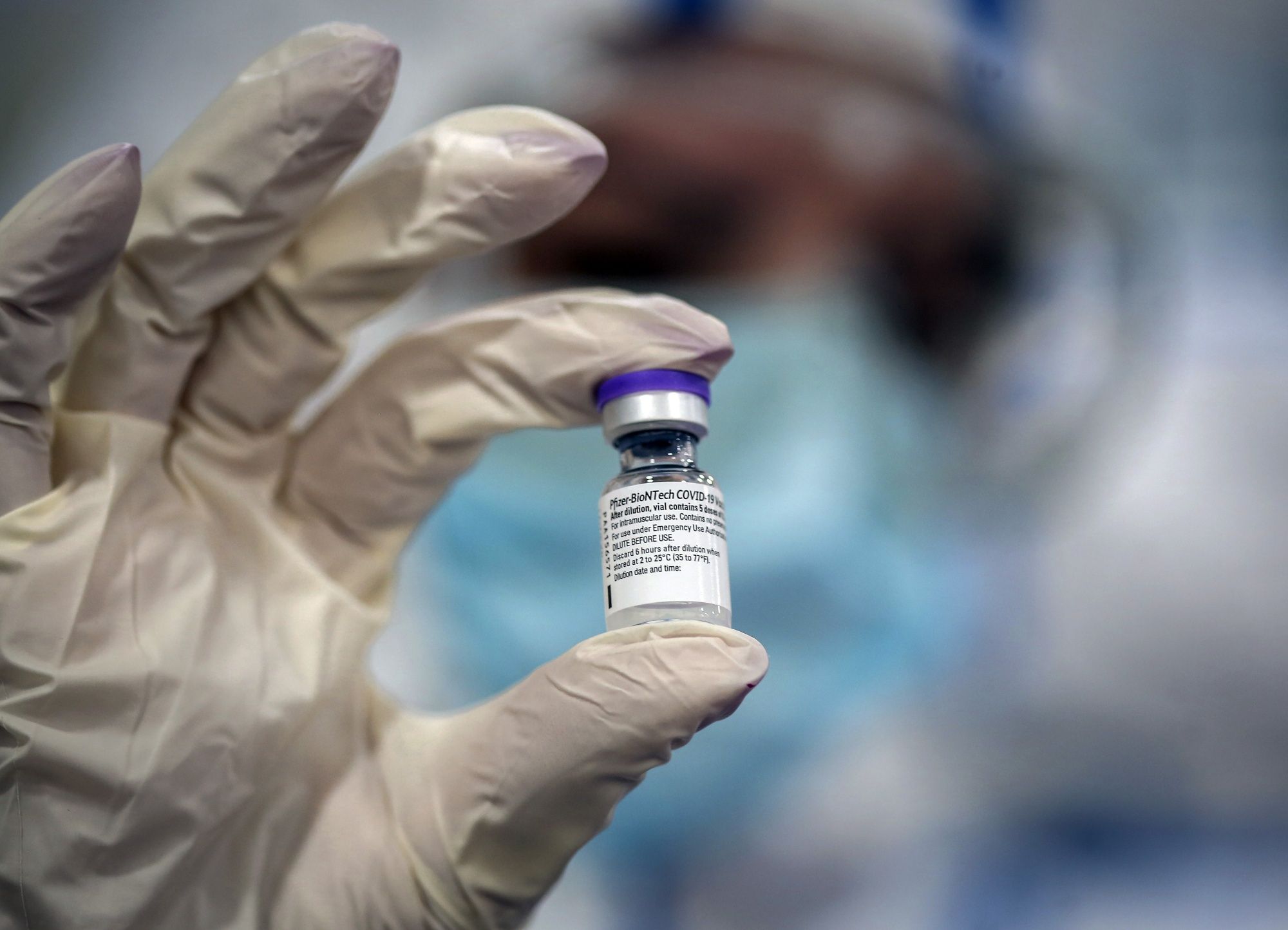 A healthcare worker holds a vial of the Pfizer-BioNTech Covid-19 vaccine at the Mother and Child Hospital in Belgrade, Serbia, on Sunday, Jan. 10, 2021. Russian Direct Investment Fund (RDIF) signed an agreement with Serbian government to supply 2 million doses of Sputnik V Covid-19 vaccine, RDIF says in statement. Photographer: Oliver Bunic/Bloomberg
