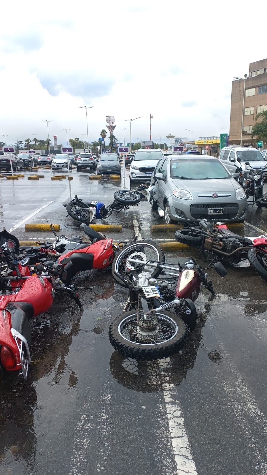 Tormenta y viento. Motos tiradas en el estacionamiento del aeropuerto de Ezeiza.