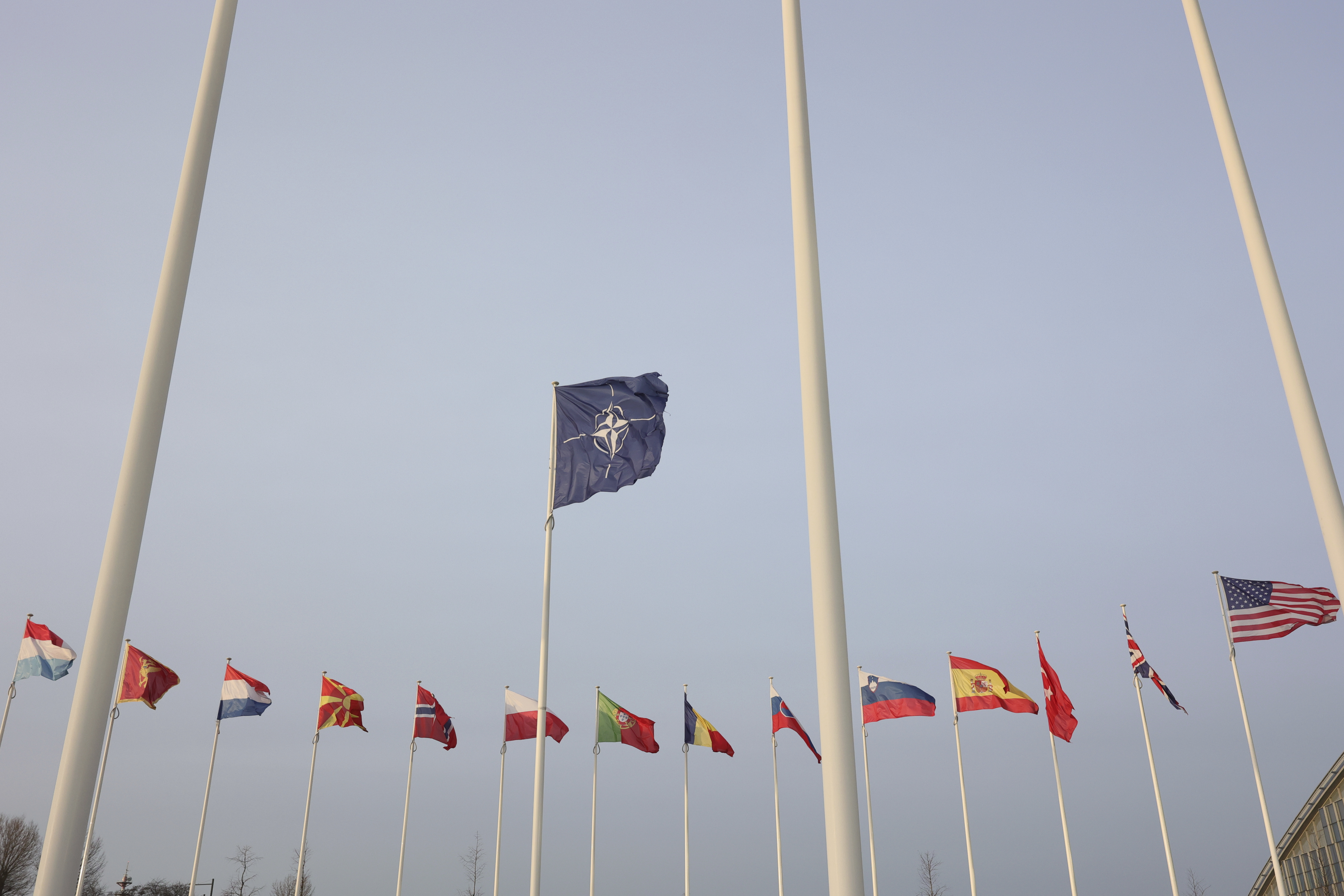 Flags of NATO members adorn the exterior of NATO headquarters ahead of the signing of a joint declaration by the military alliance and the European Union in Brussels, Tuesday, January 10, 2023. (AP Photo/Olivier Matthys)