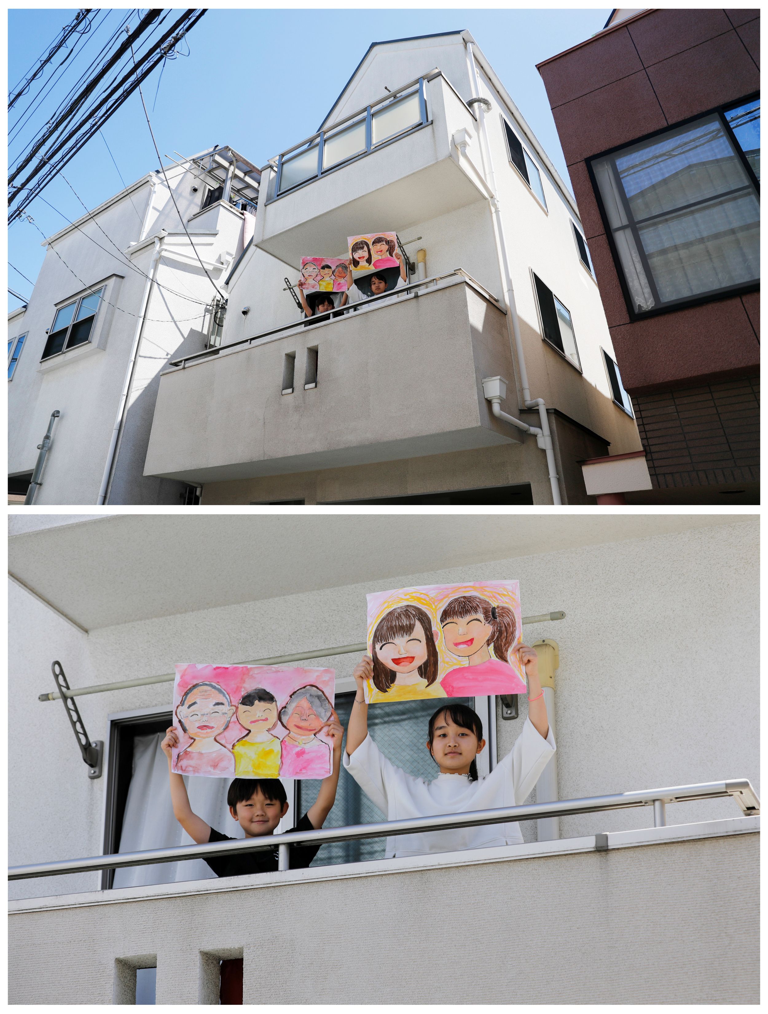 Reku Matsui, 8, y Yaya Matsui, 12, sostienen dibujos que hicieron durante el brote de coronavirus, en el balcón de su casa en Tokyo, Japón, el 19 de abril de 2020.