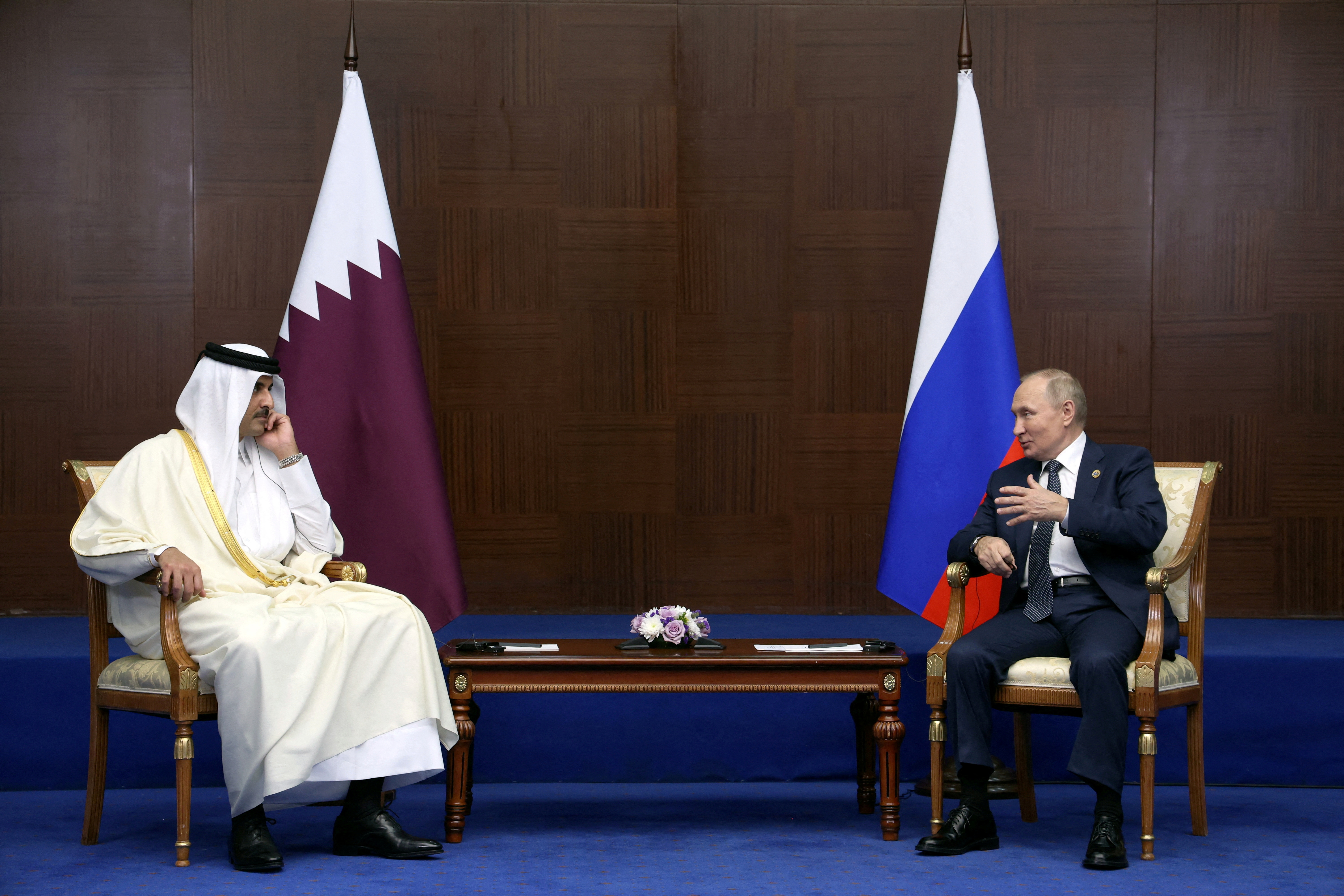 The Emir of Qatar, Sheikh Tamim bin Hamad al-Thani during a meeting with Russian President Vladimir Putin.  Sputnik/Vyacheslav Prokofyev/Pool via REUTERS.