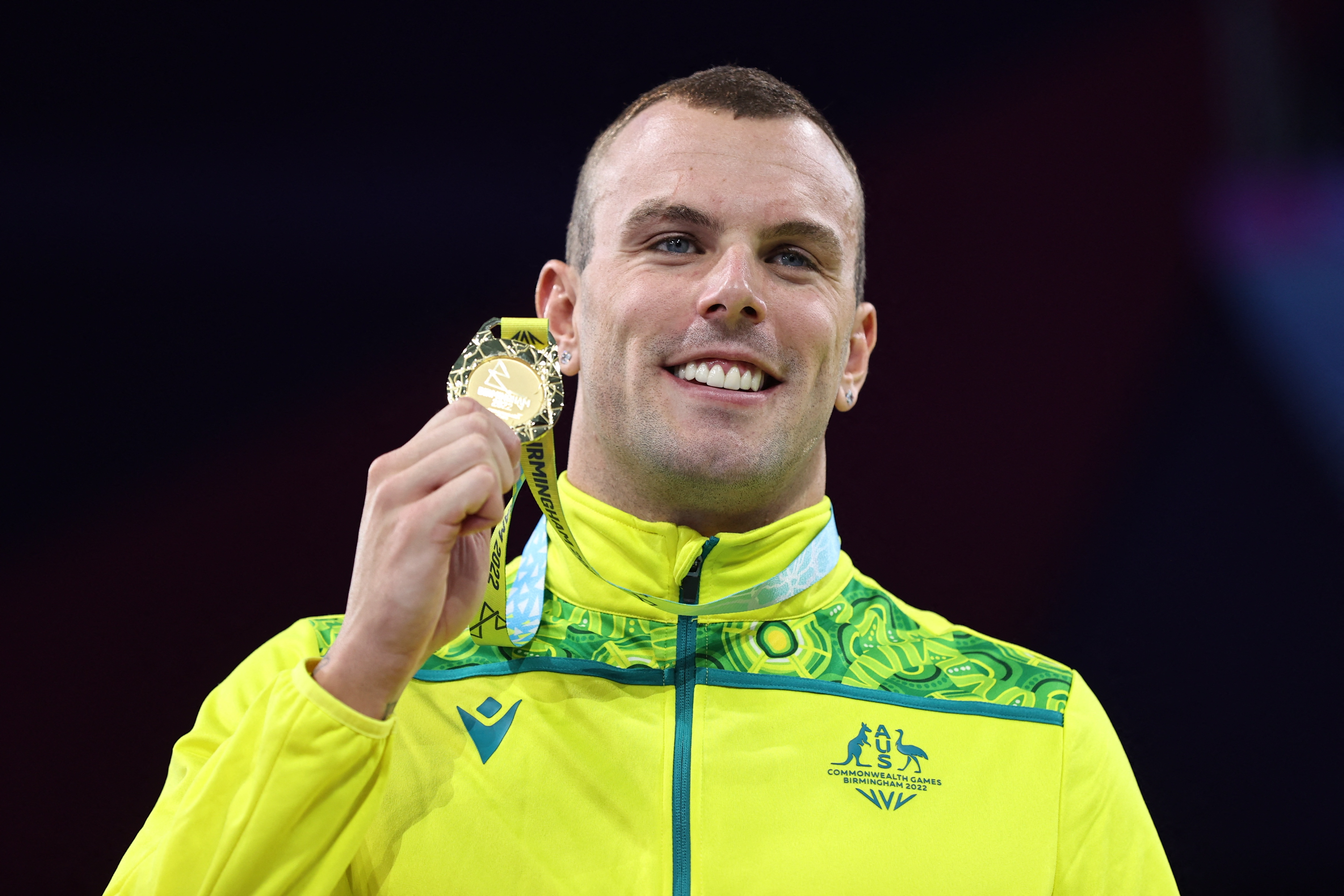Commonwealth Games - Swimming - Men's 100m Freestyle - Final- Medal Ceremony - Sandwell Aquatics Centre, Birmingham, Britain - August 1, 2022 Gold Medallist Australia's Kyle Chalmers celebrates on the podium during the medal ceremony REUTERS/Stoyan Nenov