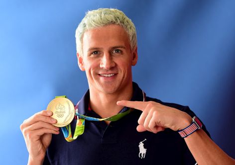 RIO DE JANEIRO, BRAZIL - AUGUST 12:  (BROADCAST - OUT) Swimmer, Ryan Lochte of the United States poses for a photo with his gold medal on the Today show set on Copacabana Beach on August 12, 2016 in Rio de Janeiro, Brazil.  (Photo by Harry How/Getty Images)