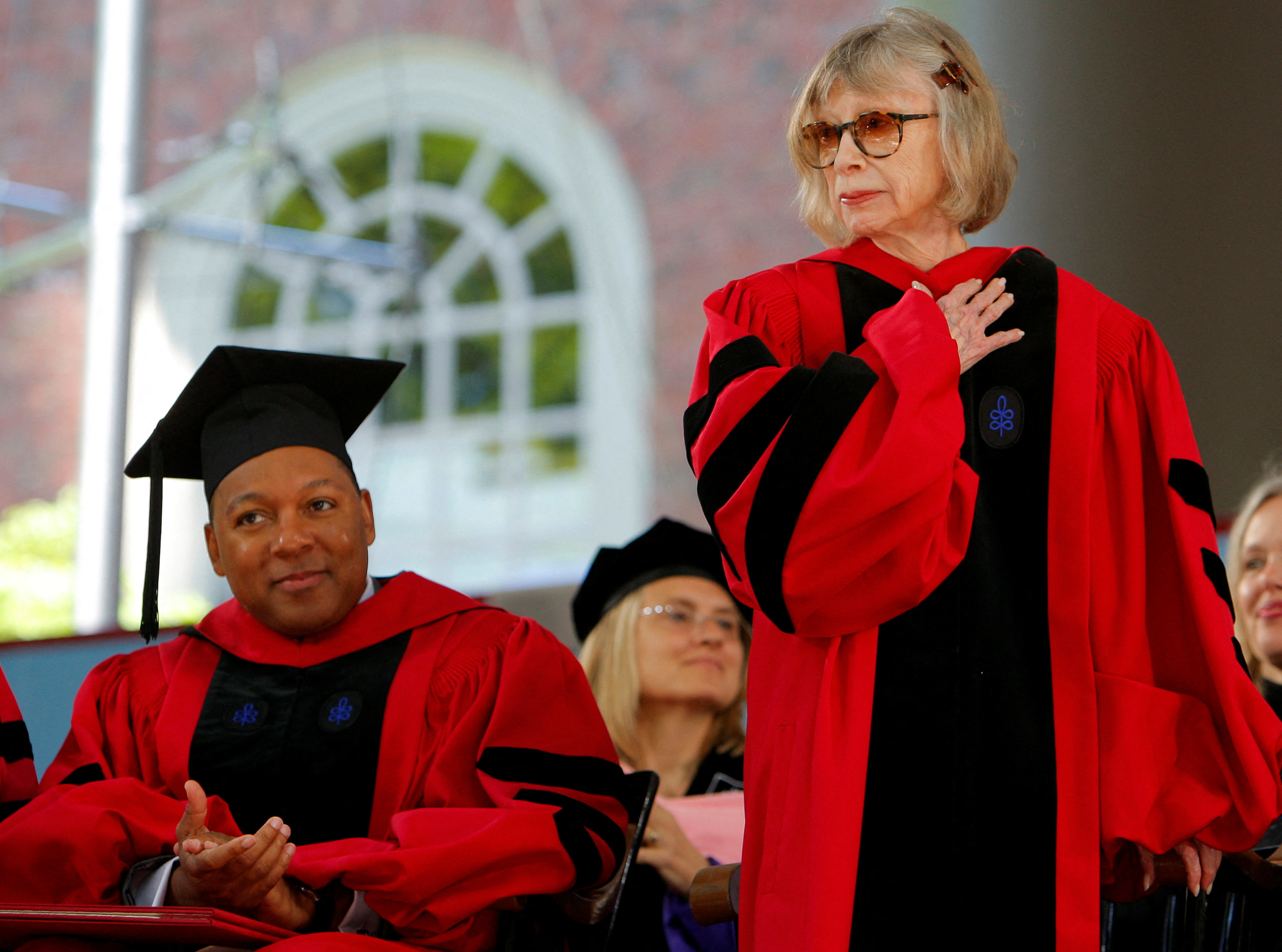 El músico Wynton Marsalis (izquierda) aplaude mientras la autora Joan Didion (derecha) recibe un título honorario de Doctor en Letras en la 358a graduación de la Universidad de Harvard en Cambridge en 2009 (REUTERS / Brian Snyder)