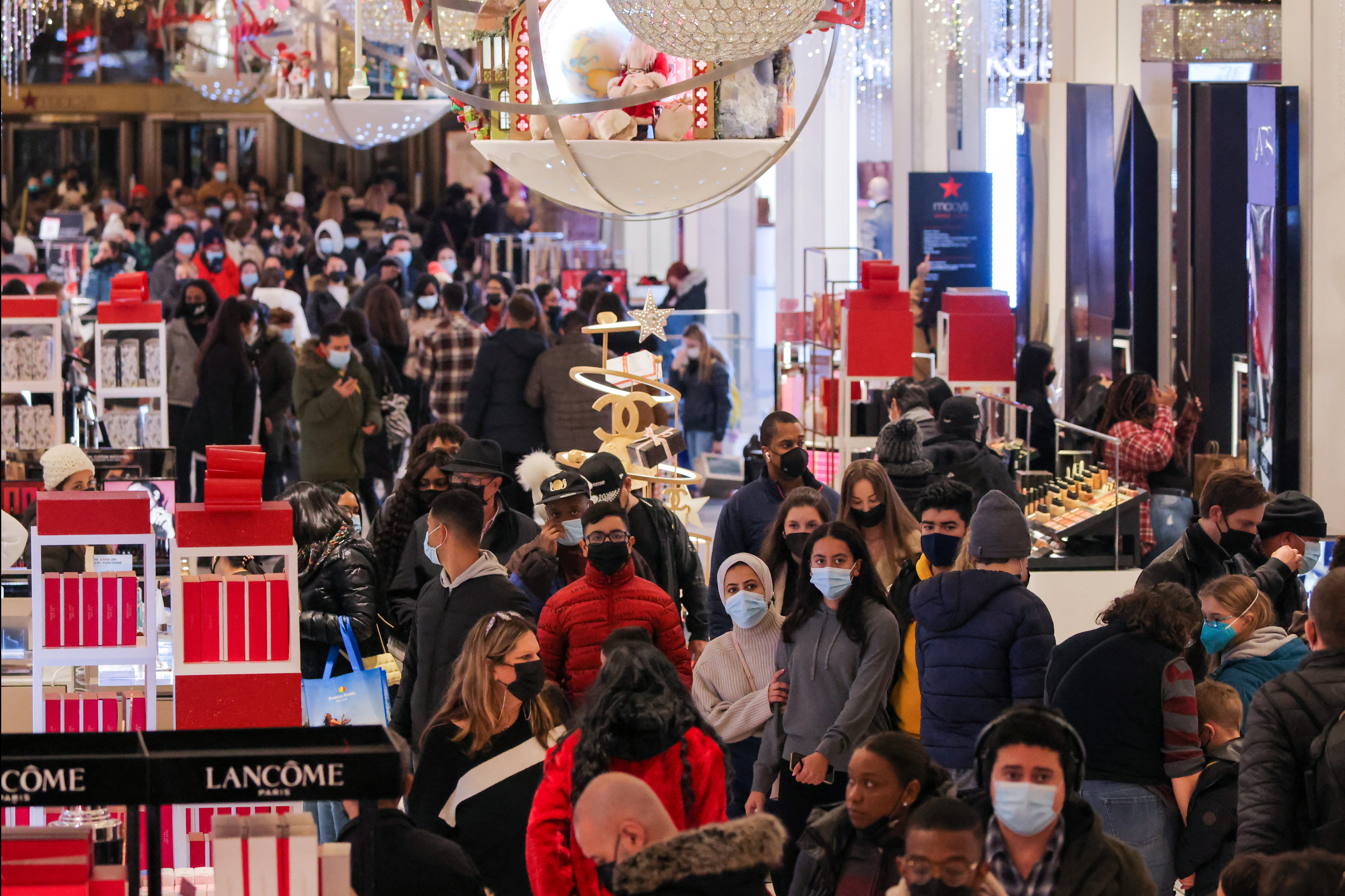 Personas con máscaras faciales compran en Macy's Herald Square, en Manhattan, el último sábado antes de Navidad mientras la variante del coronavirus Ómicron sigue propagándose este 18 de diciembre de 2021 (REUTERS/Andrew Kelly)