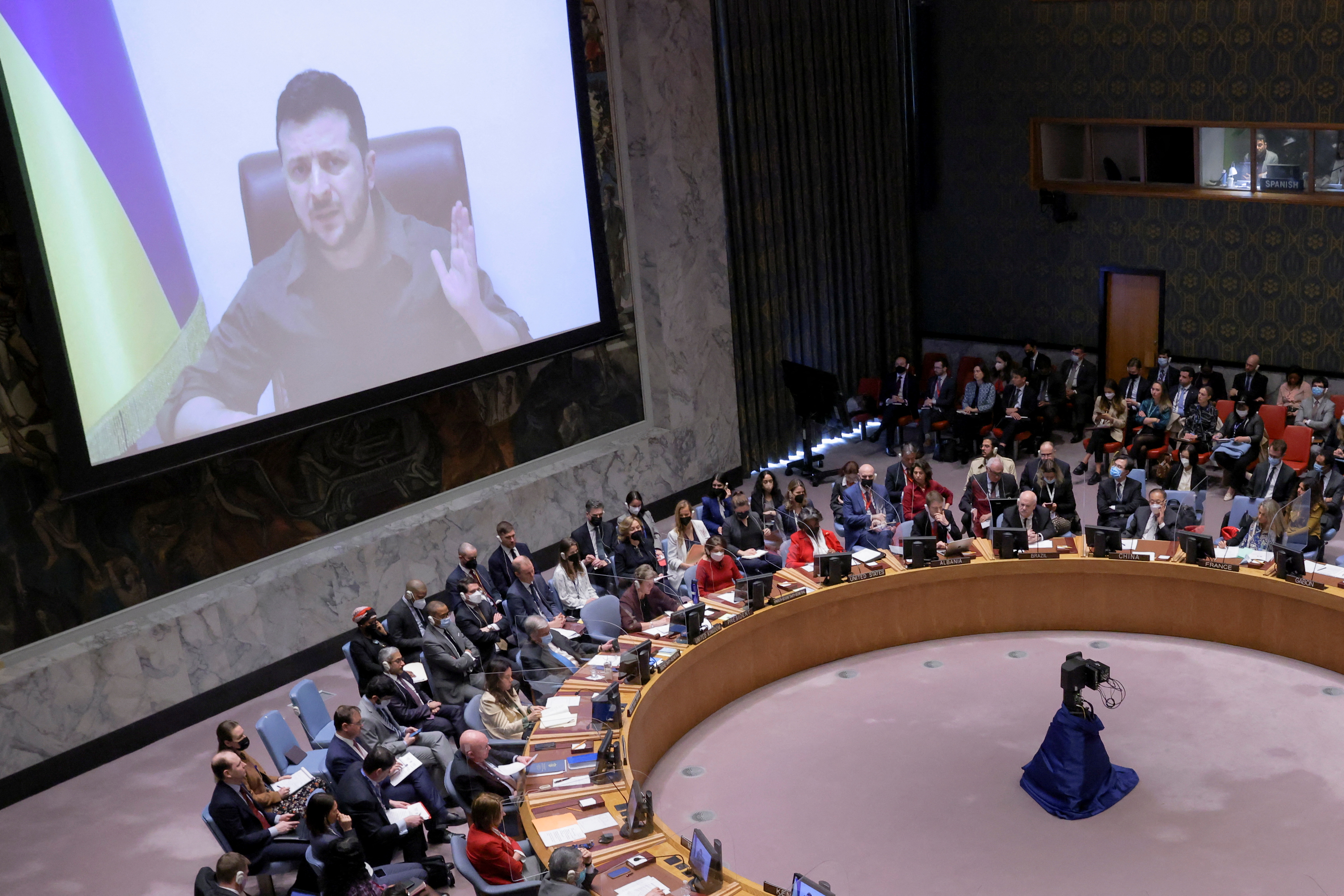 Ukrainian President Volodymyr Zelenskiy appears on a screen as he addresses the United Nations Security Council via video link during a meeting amid Russia's invasion of Ukraine, at the United Nations Headquarters in Manhattan, New York City, New York, U.S., April 5, 2022. REUTERS/Andrew Kelly