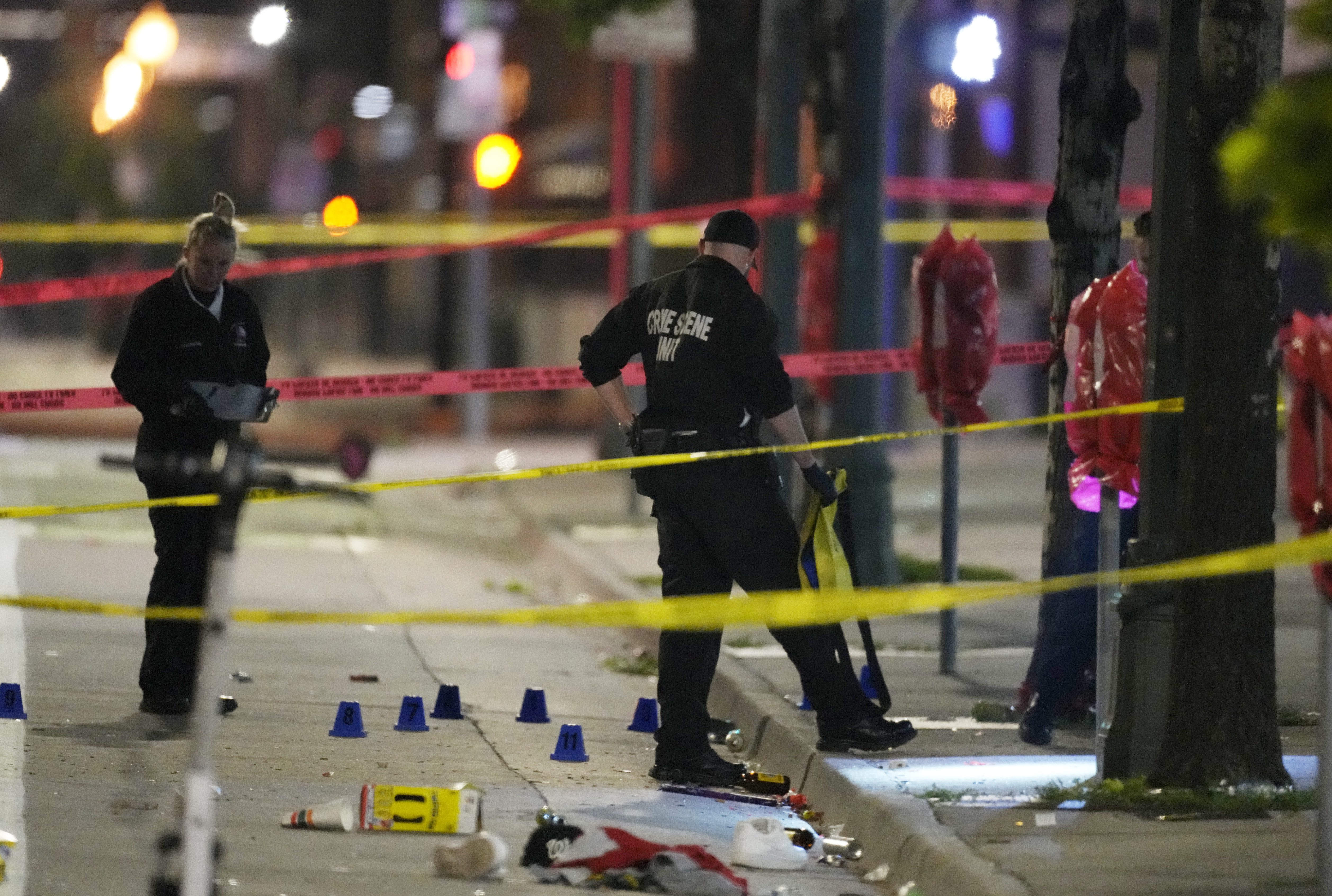 Investigadores del Departamento de Policía de Denver, trabajan en la escena de un tiroteo masivo en Market Street, entre la 20ma y la 21ra avenidas, durante al celebración del título de la NBA de los Nuggets, el 13 de junio de 2023, en Denver. (AP Foto/David Zalubowski)