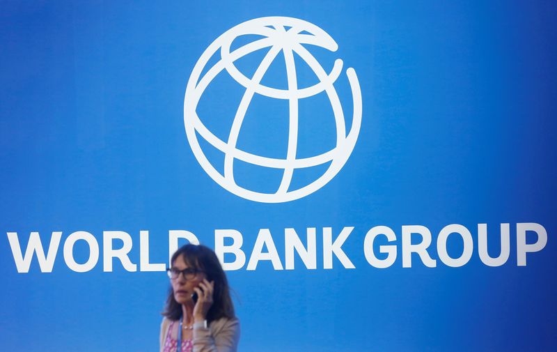 Stock image.  A participant stands near a World Bank logo at the 2018 International Monetary Fund-World Bank Annual Meeting in Nusa Dua, Bali, Indonesia.  October 12, 2018. REUTERS/Johannes P. Christo
