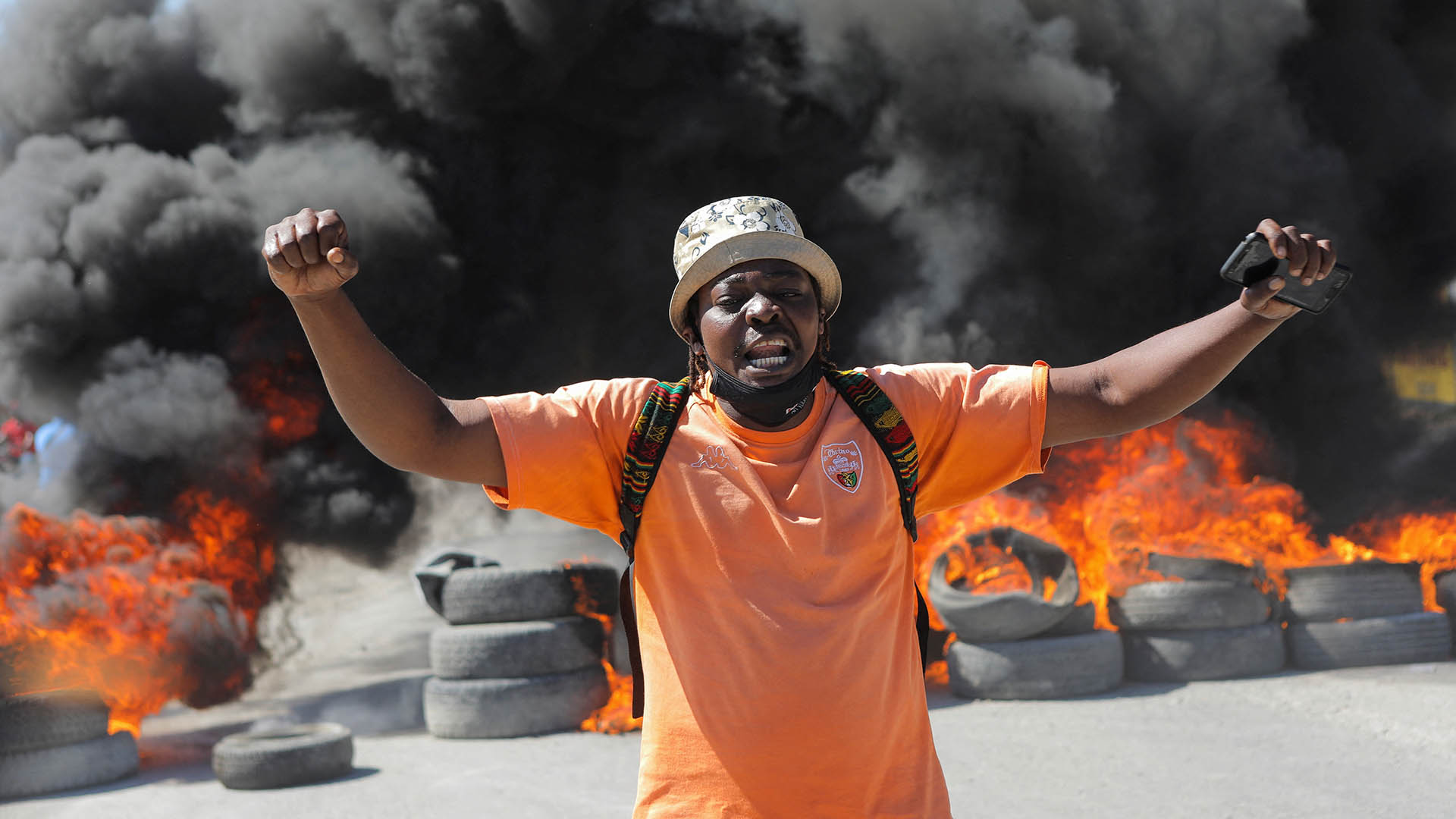 A demonstrator yells in front of a burning barricade during a protest for the recent killings of police officers by armed gangs, in Port-au-Prince, Haiti January 26, 2023. REUTERS/Ralph Tedy Erol