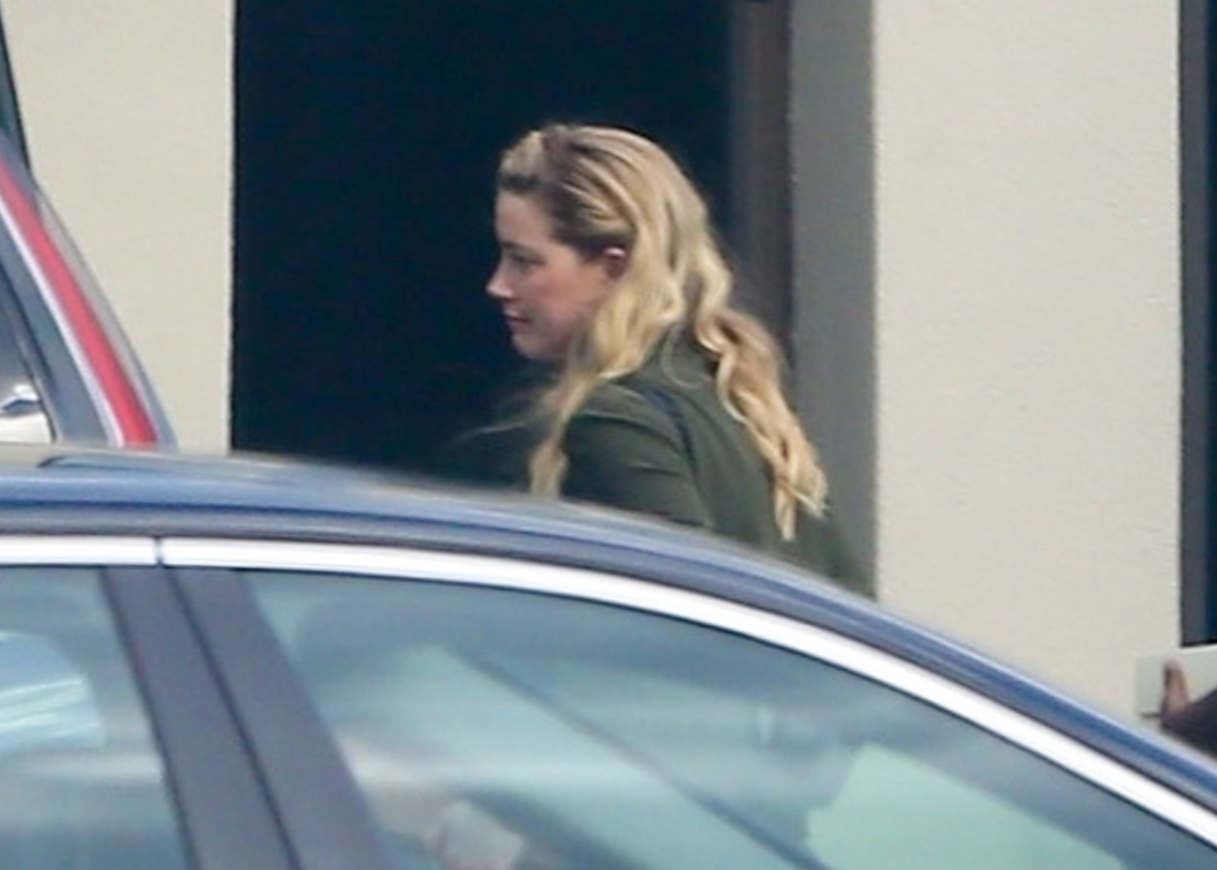 Amber Heard catches a flight at Teterboro Airport in Bergen County, New Jersey, after a quick trip to New York City.  The actress was seen with security personnel, her sister and her assistant.  It was her first public appearance since she lost her libel suit against her ex, Johnny Depp, last week (Photo: The Grosby Group)