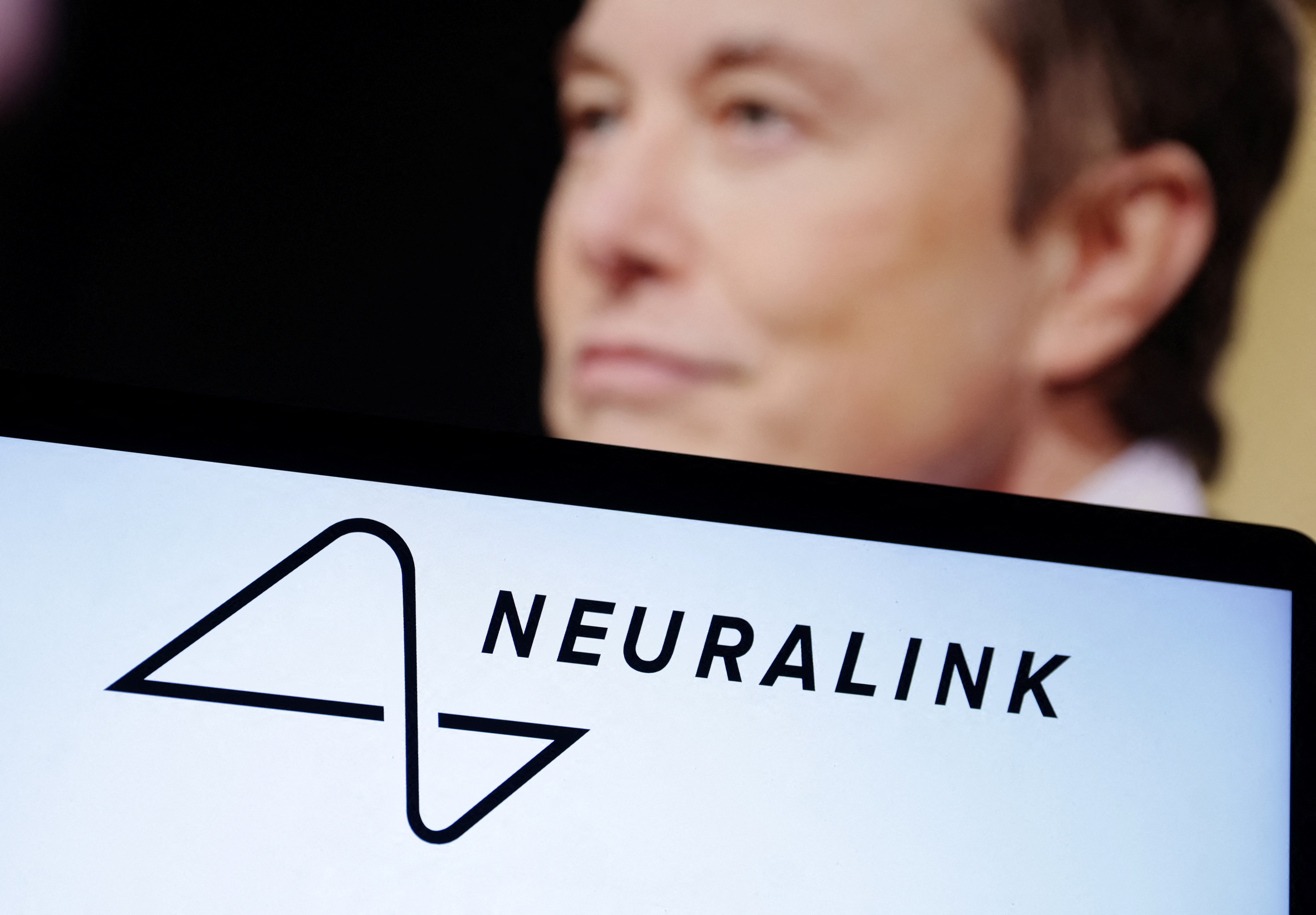 Neuralink logo and Elon Musk photo are seen in this illustration taken, December 19, 2022. REUTERS/Dado Ruvic/Illustration