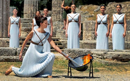 Greek actress Katerina Lehou , playing the role of High Priestess, lights a torch from the sun's rays reflected in a parabolic mirror during the dress rehearsal for the Olympic flame lighting ceremony for the Rio 2016  Olympic Games at the site of ancient Olympia in Greece, April 20, 2016.    REUTERS/Yannis Behrakis 