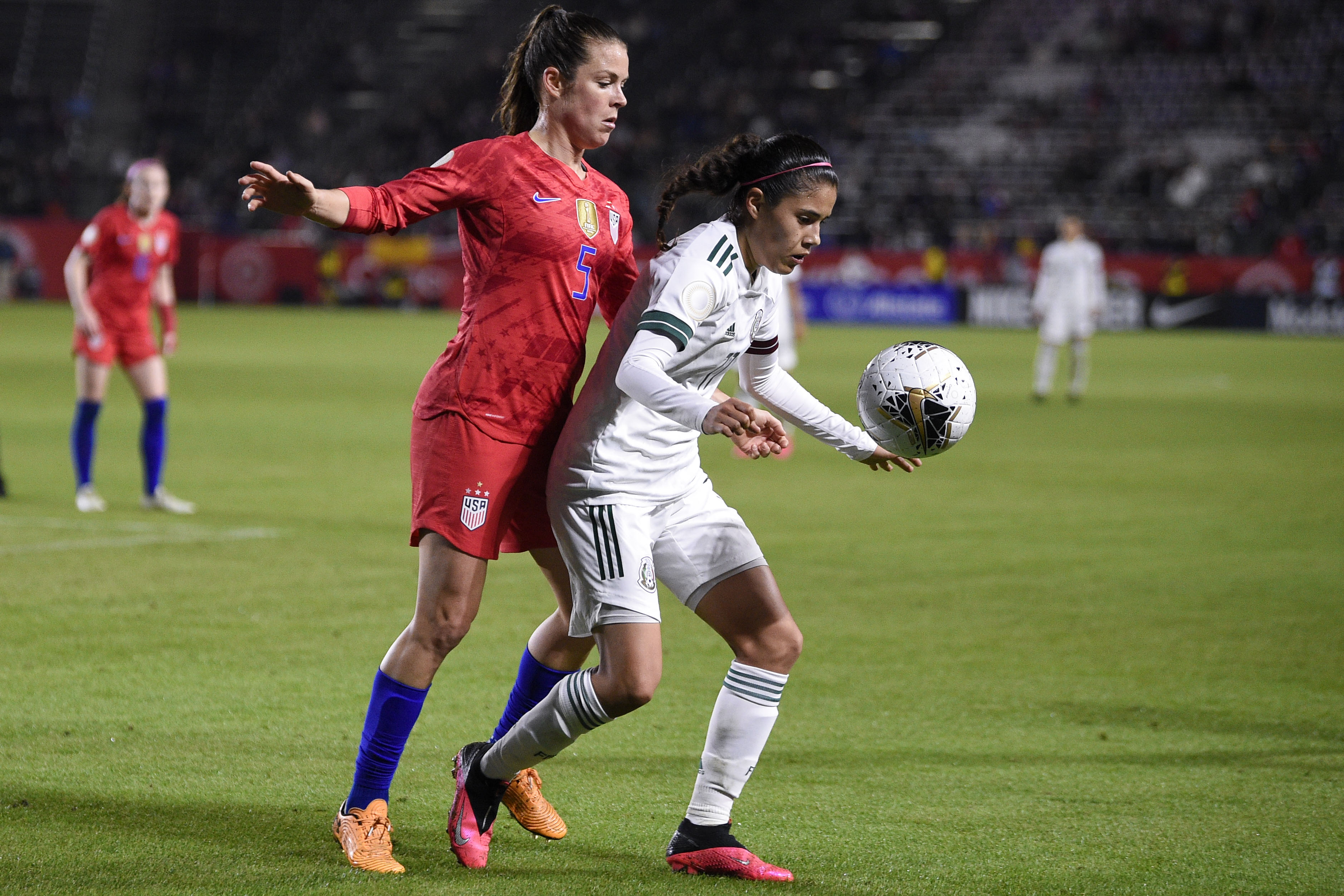 Feb 7, 2020; Los Angeles, California, USA; Mexico midfielder Jacqueline Ovalle (11) handles the ball while pressured by United States defender Kelley O'hara (5) during the second half of the CONCACAF Women's Olympic Qualifying soccer tournament at Dignity Health Sports Park. Mandatory Credit: Kelvin Kuo-USA TODAY Sports