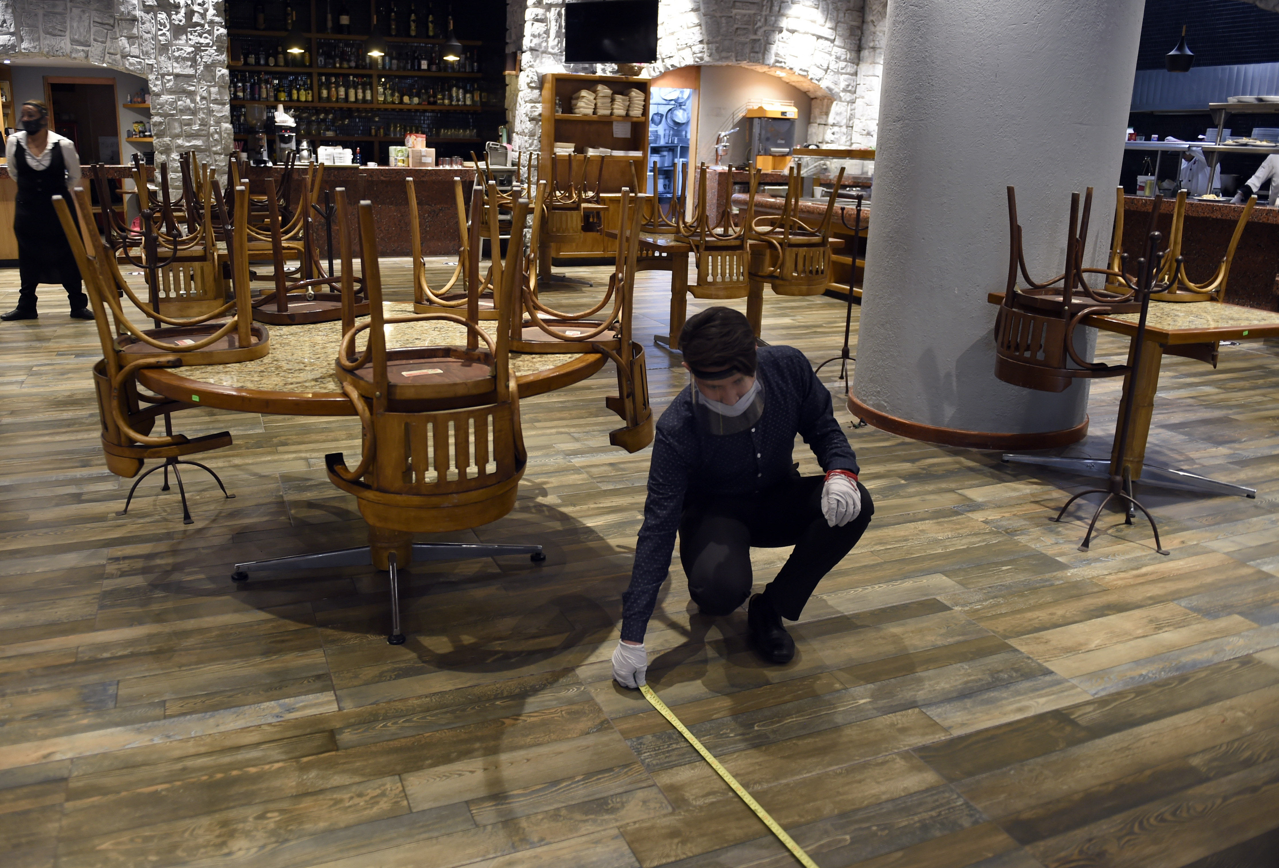 Un empleado del restaurante La Capilla organiza mesas para mantener la distancia social en la Ciudad de México, el 29 de junio de 2020 durante la pandemia COVID-19. (Foto: ALFREDO ESTRELLA / AFP)