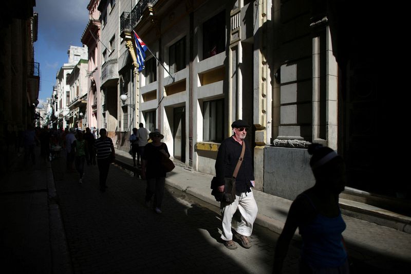 A tourist walks through the streets of Havana as power cuts hit the streets (REUTERS/Alexandre Meneghini/File Photo)