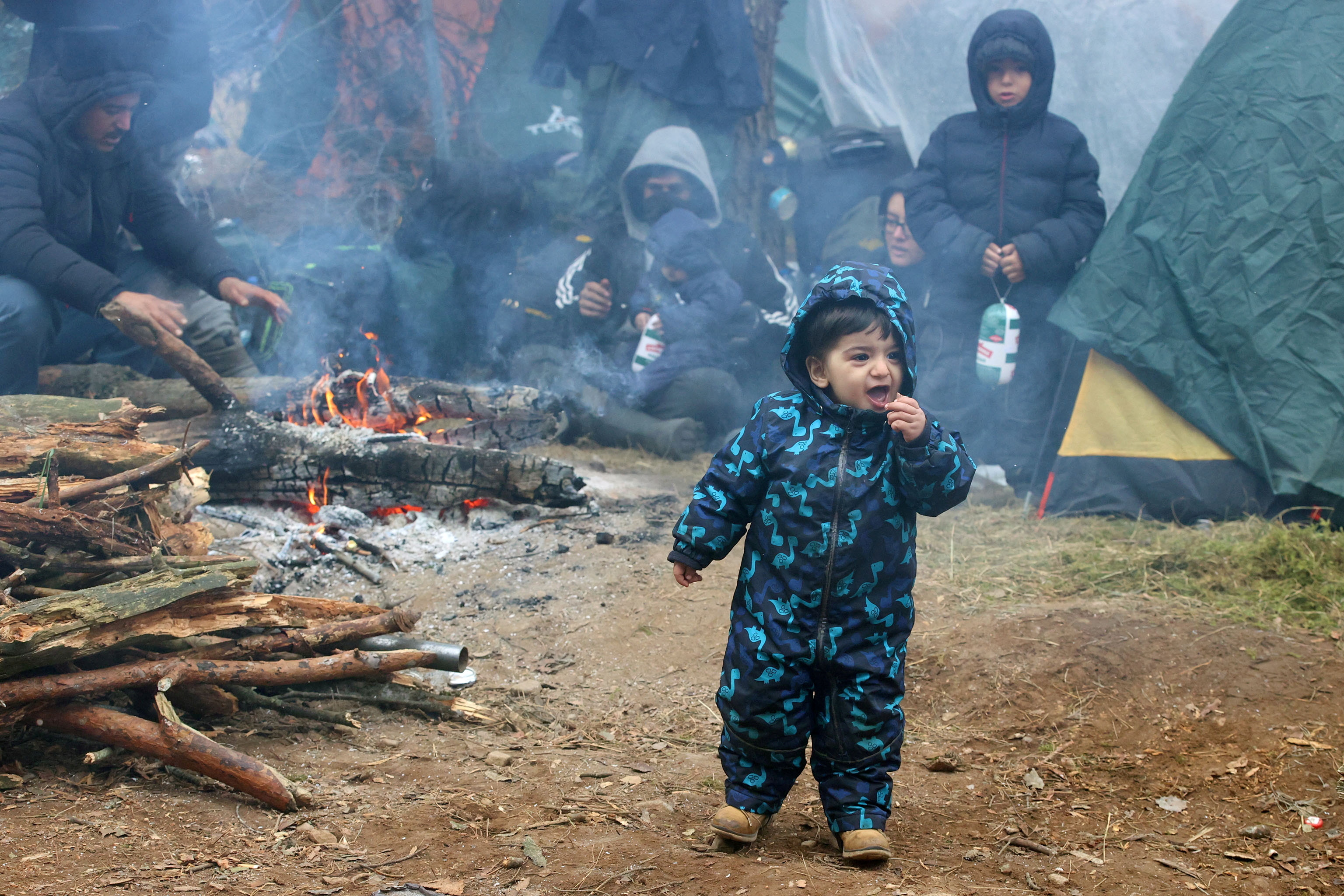 Un niño en un campo de migrantes en la frontera entre Polonia y Bielorrusia (Leonid Scheglov/BelTA/REUTERS)