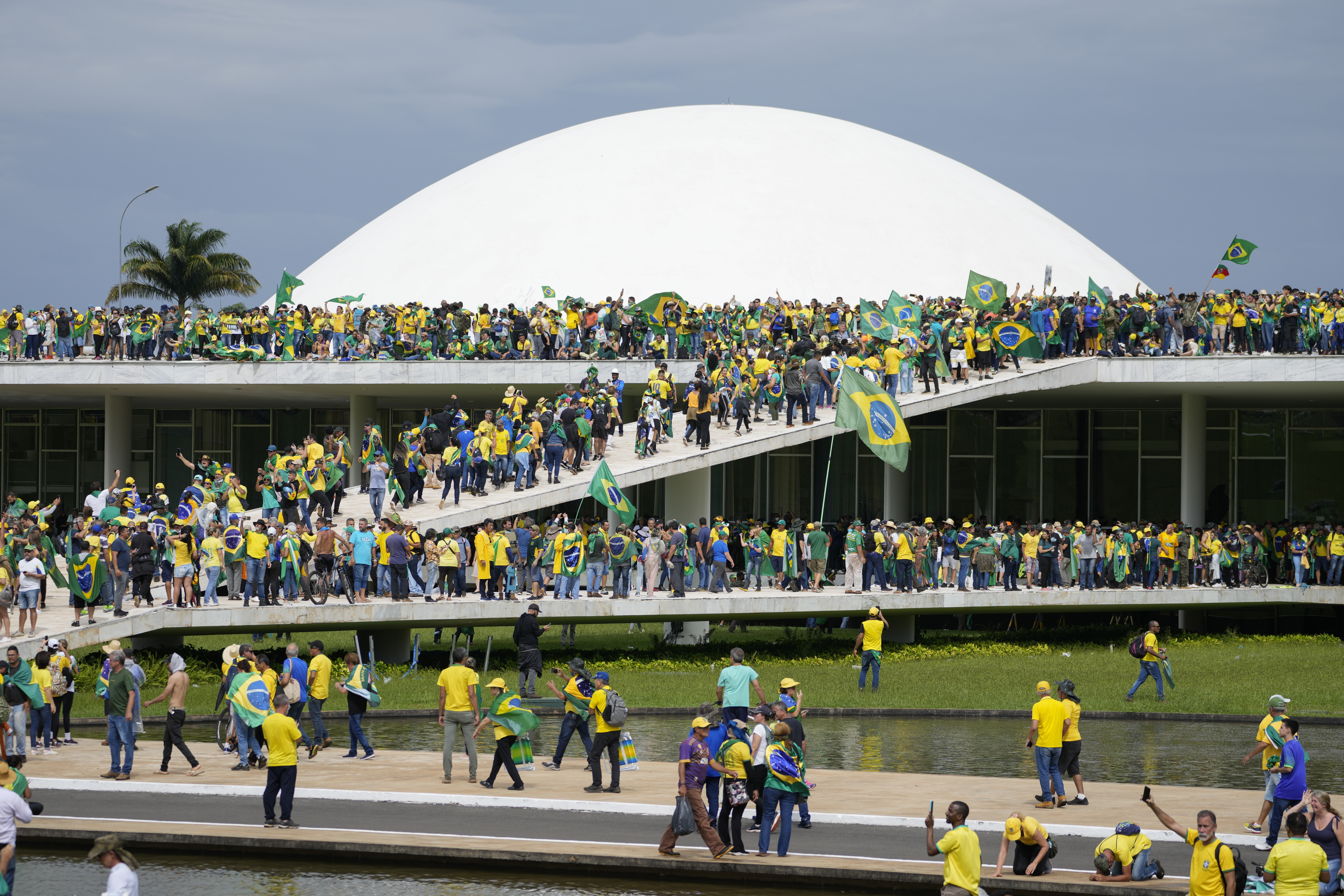 Protesters, supporters of former Brazilian President Jair Bolsonaro, break into Brazil's National Congress, in Brasilia, Sunday, Jan. 8, 2023. (AP Photo/Eraldo Peres)