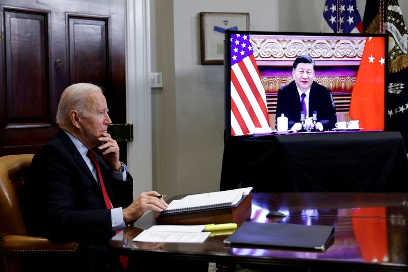 FILE PHOTO: U.S. President Joe Biden speaks with Chinese President Xi Jinping from the White House in Washington, U.S., on Nov. 15, 2021.  REUTERS/Jonathan Ernst/File Photo