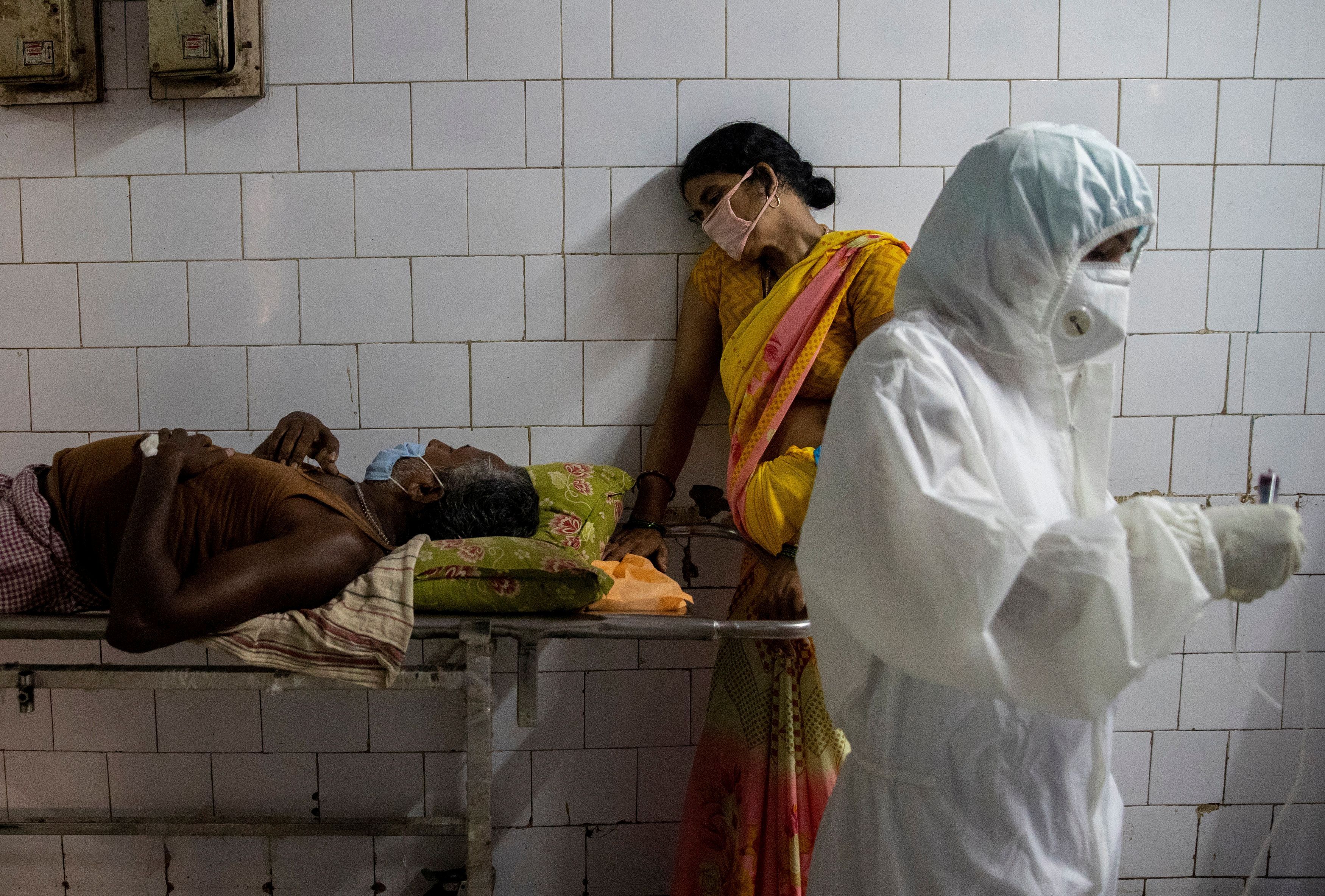 Una mujer se apoya en una camilla sosteniendo a su marido en el pasillo de la sala de urgencias del Colegio Médico y Hospital Jawahar Lal Nehru, durante el brote de la enfermedad COVID-19, en Bhagalpur, en el estado oriental de Bihar, India, 27 de julio de 2020.