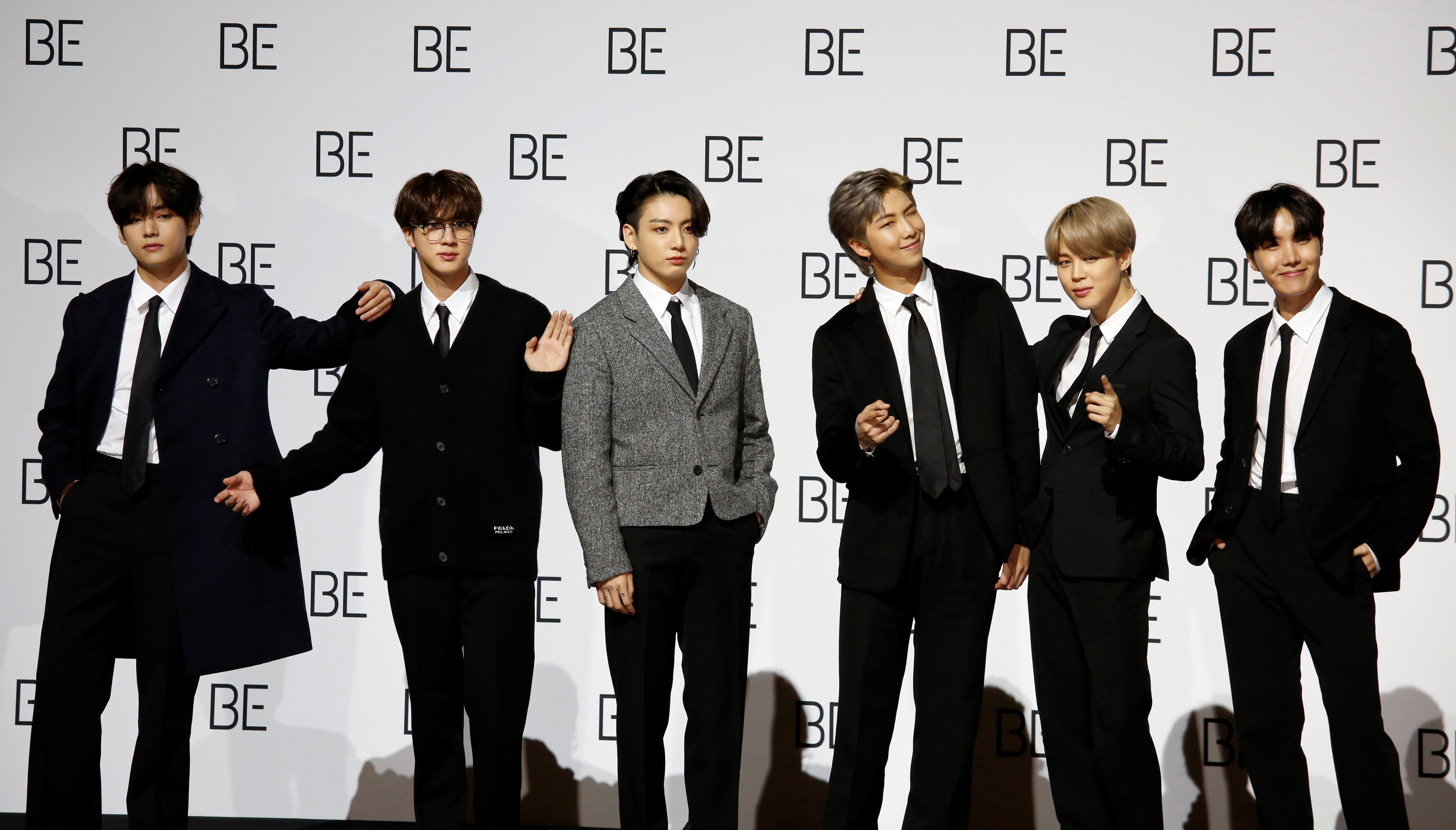 Members of K-pop boy band BTS pose for photographs during a news conference promoting their new album "BE(Deluxe Edition)" in Seoul, South Korea, November 20, 2020.    REUTERS/Heo Ran