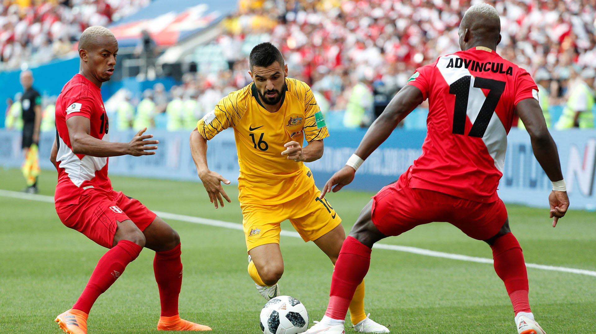 Soccer Football - World Cup - Group C - Australia vs Peru - Fisht Stadium, Sochi, Russia - June 26, 2018 Australia's Aziz Behich in action with Peru's Luis Advincula and Andre Carrillo REUTERS/Max Rossi