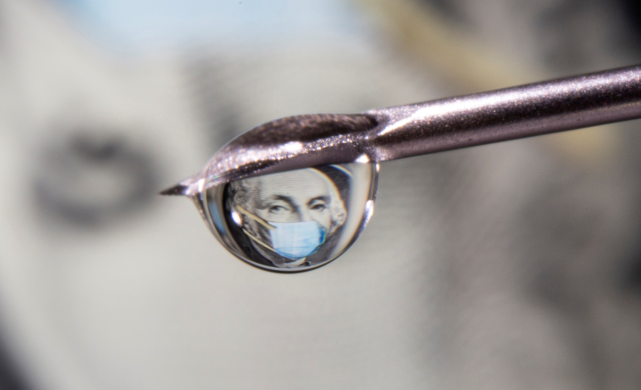 FILE PHOTO: George Washington is seen with a printed medical mask on a one dollar bill reflected in a drop on a syringe needle in this illustration taken November 9, 2020. REUTERS/Dado Ruvic/Illustration/File Photo