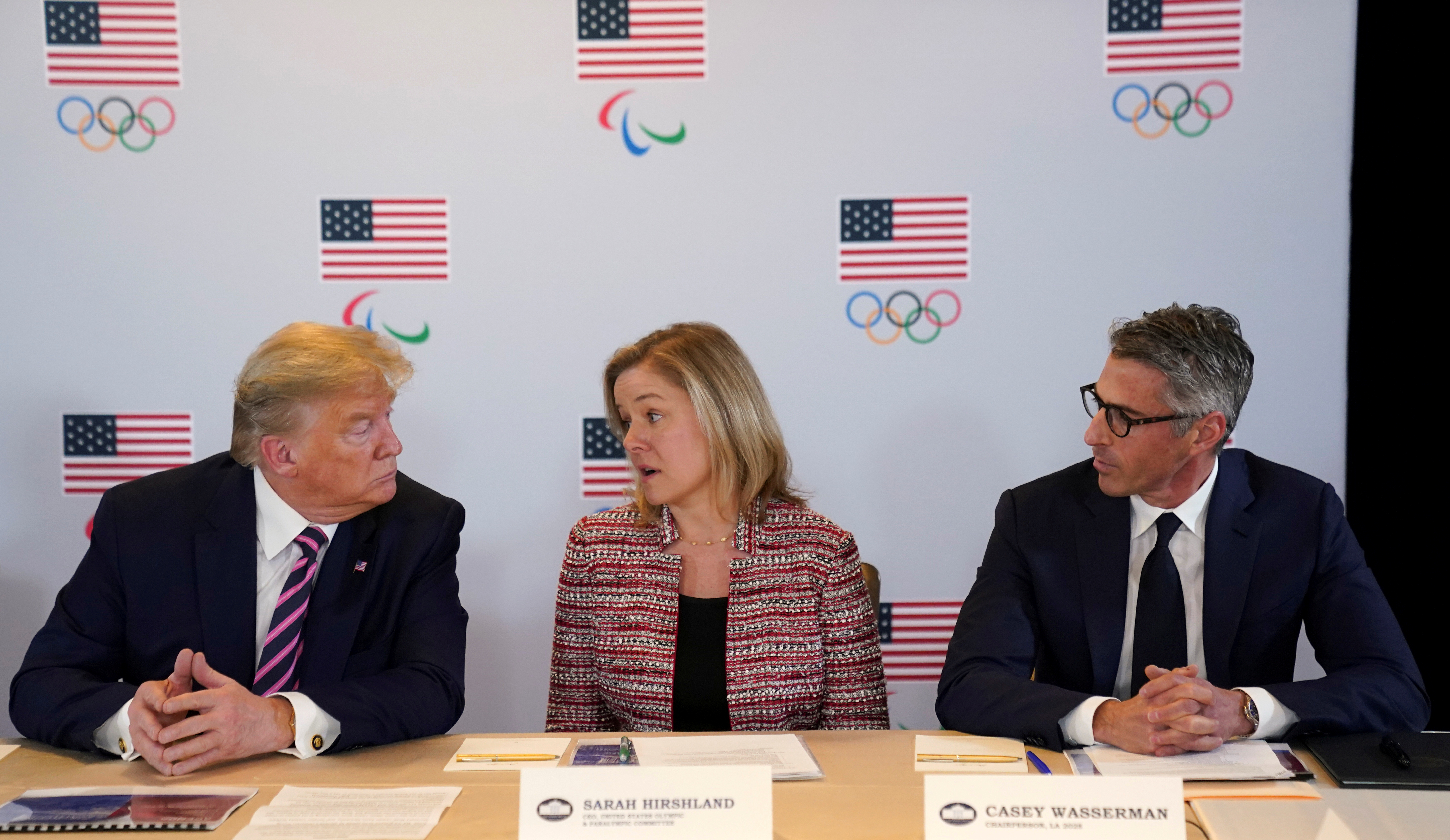 FILE PHOTO: U.S. President Donald Trump talks with Sarah Hirshland, CEO of the United States Olympic & Paralympic Committee and Casey Wasserman, chairman of LA 2028, during an LA 2028 Olympic briefing in Los Angeles, California, February 18, 2020. REUTERS/Kevin Lamarque/File Photo