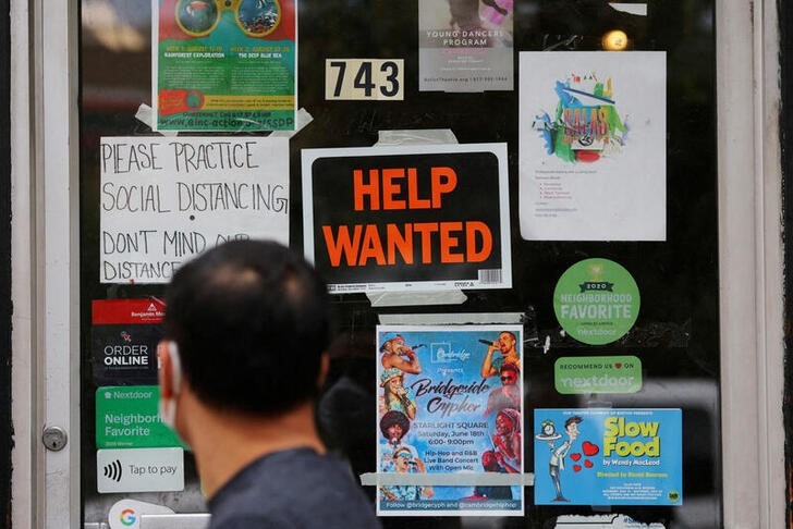 File image of a person walking past a sign offering employment at a hardware store in Cambridge, Massachusetts, USA.  July 8, 2022. REUTERS/Brian Snyder/File
