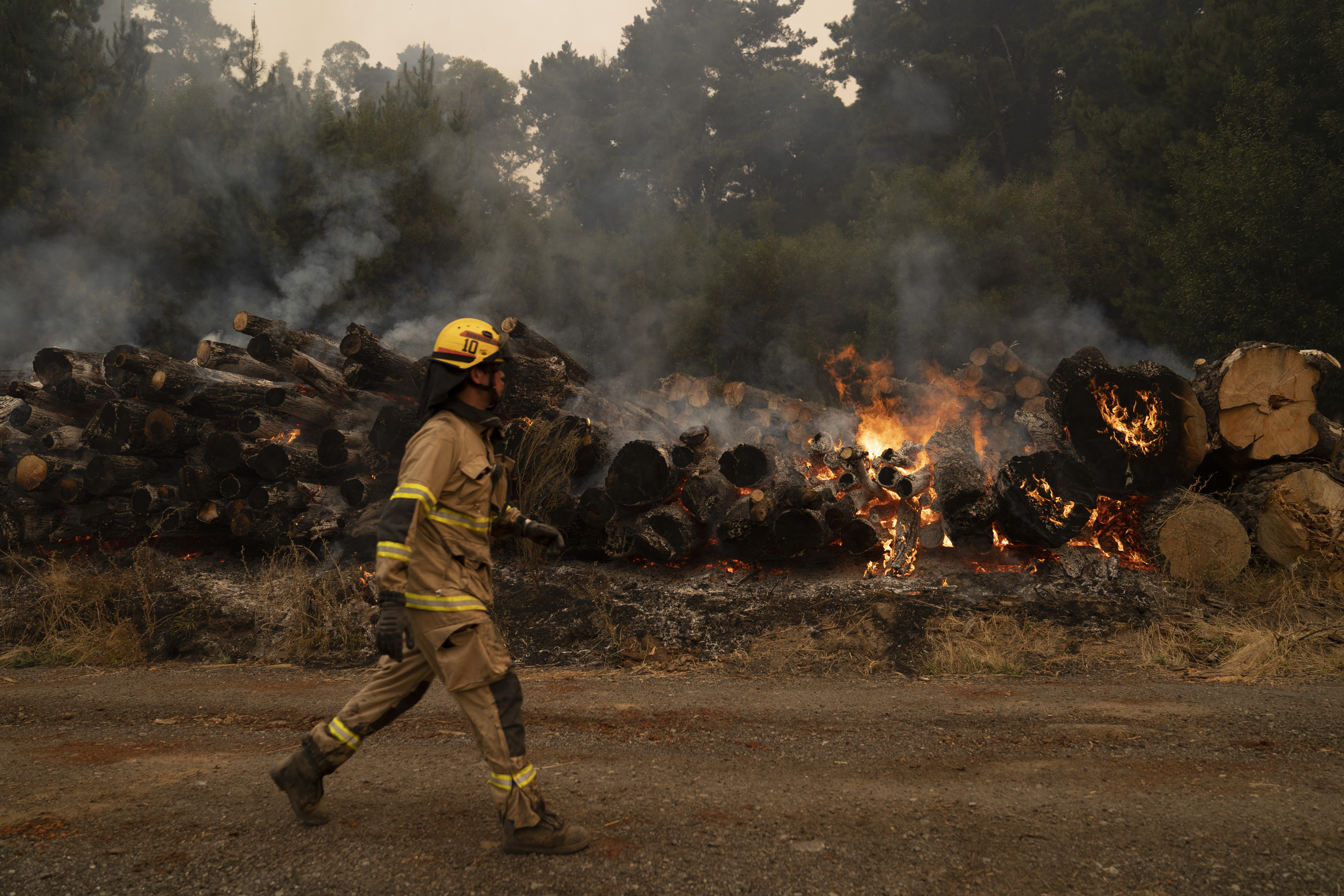 Cambio climático: bomberos trabajan para extinguir un incendio, este 7 de febrero de 2023, en Santa Juana, región de Biobío (Chile). EFE/ Adriana Thomasa