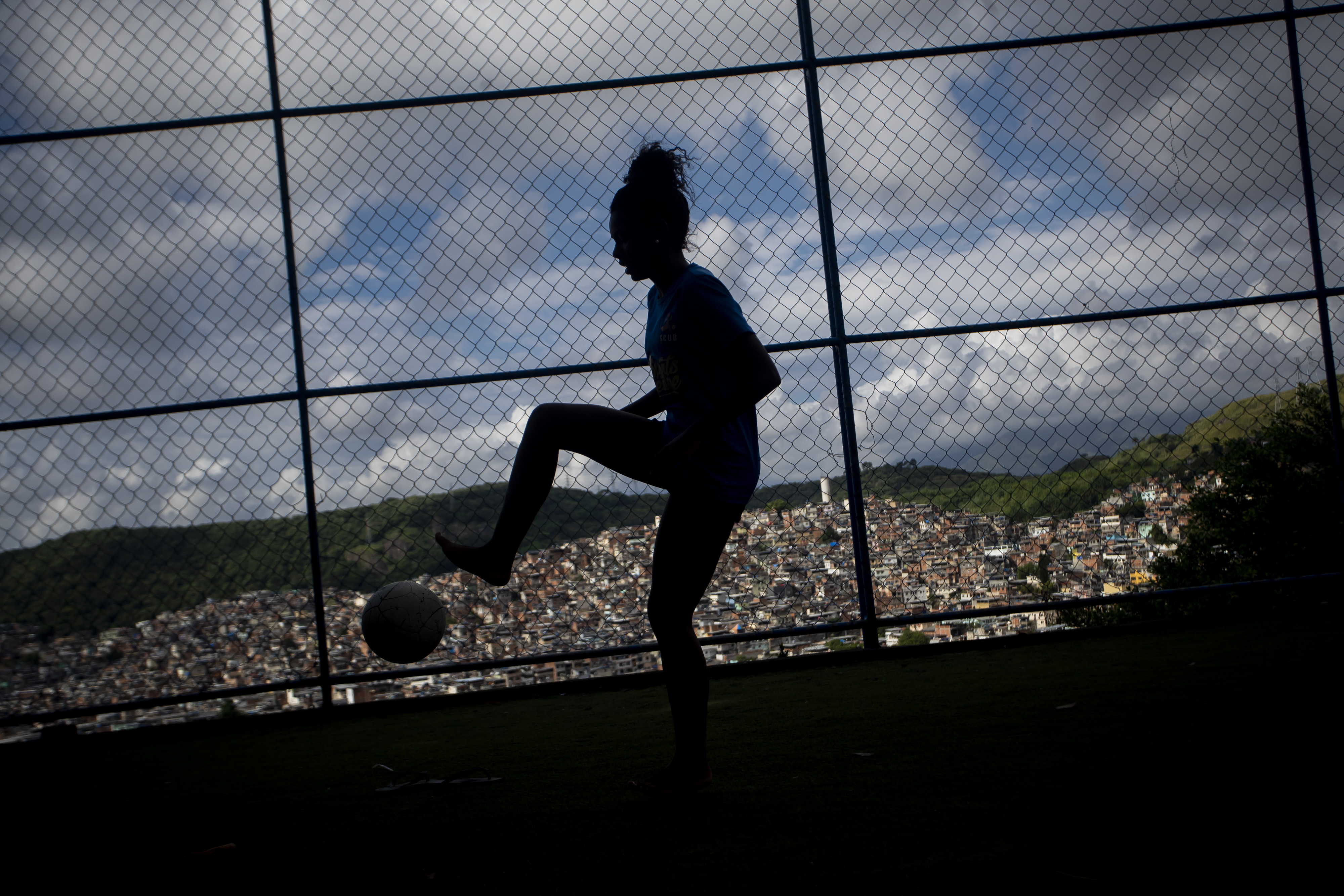 Jessica do Vale controls the ball during a street soccer training program of the NGO Street Child United Brazil, in the Complexo da Penha favela, in Rio de Janeiro, Brazil, on April 29, 2023. Girls defy the stereotype of a sport dominated by men with the support of coaches from their own community.  (AP Photo/Bruna Prado)